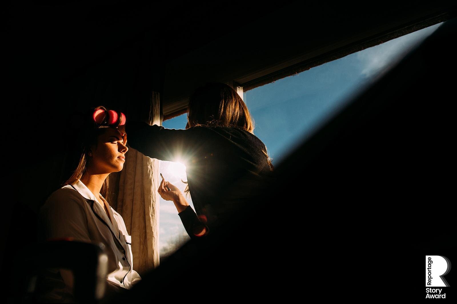  Bride having her make up done in a beam of light. 