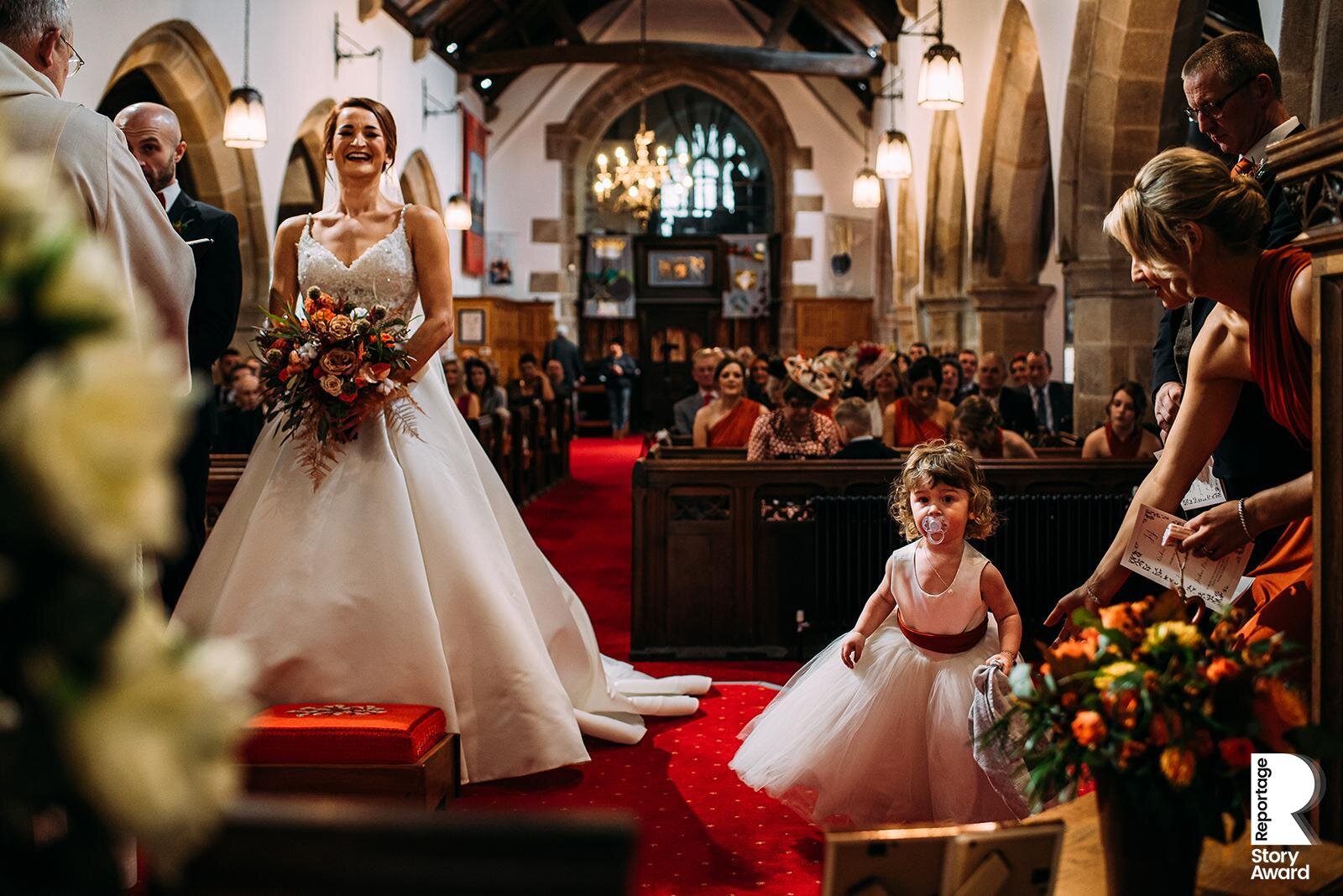 Bride laughing at her daughter during the wedding service. 