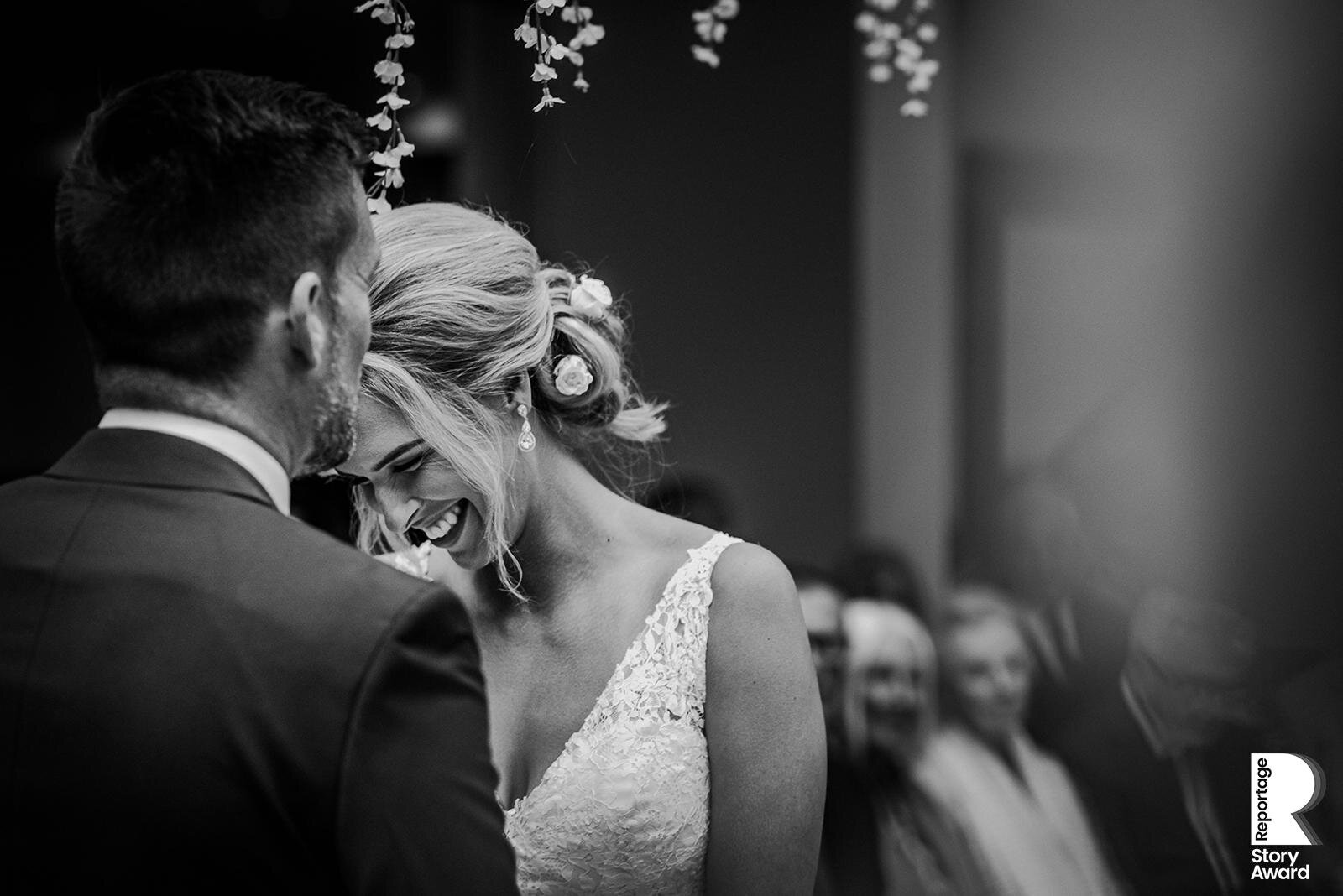  Bride laughing during the wedding ceremony. 