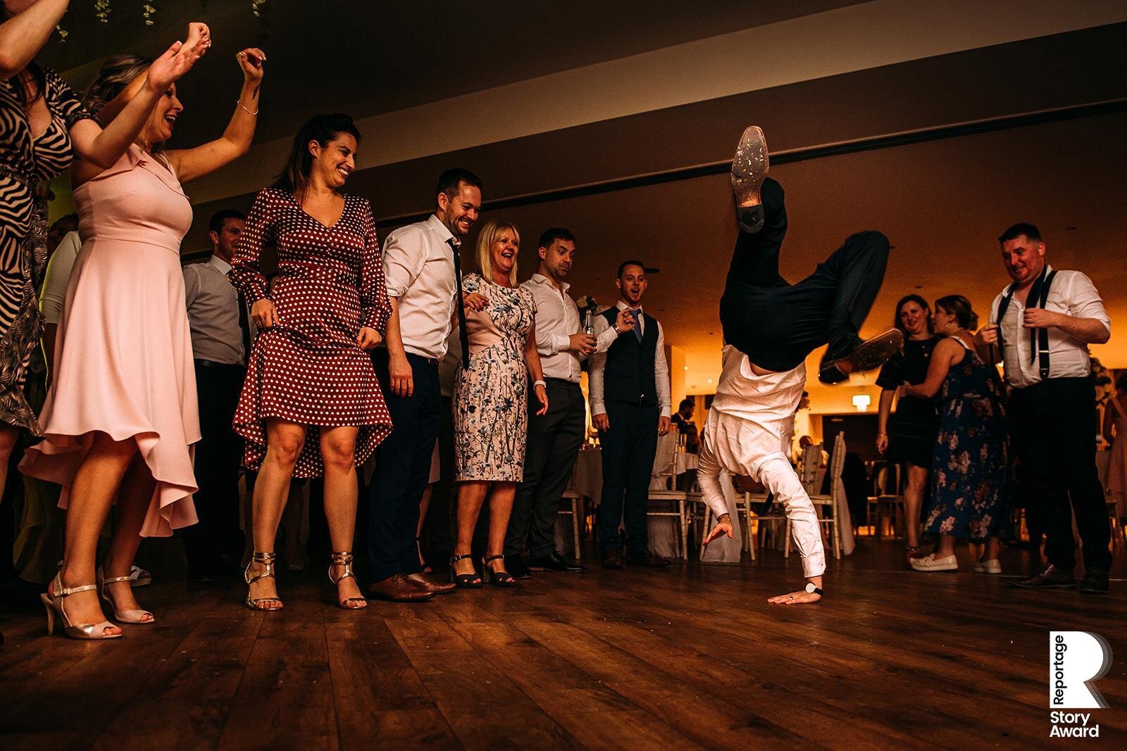  Man attempts a cartwheel on the dance floor. 