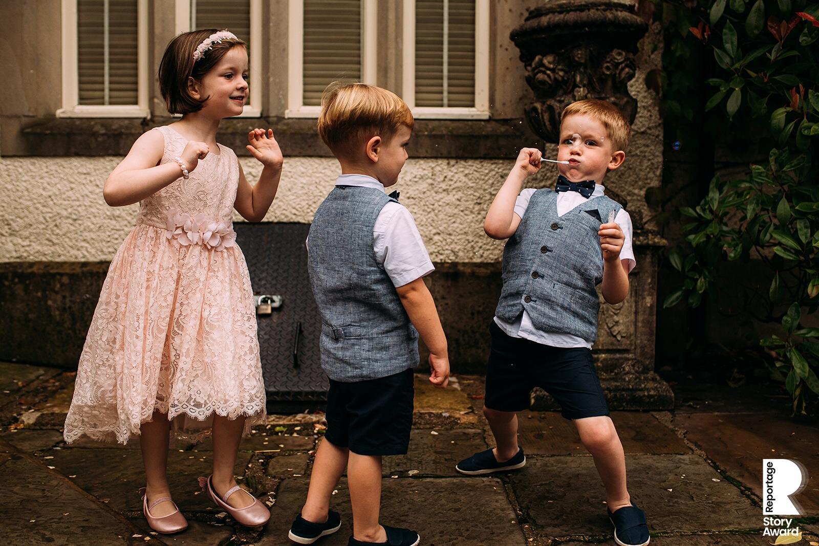  Kids playing and blowing bubbles at Mitton hall. 