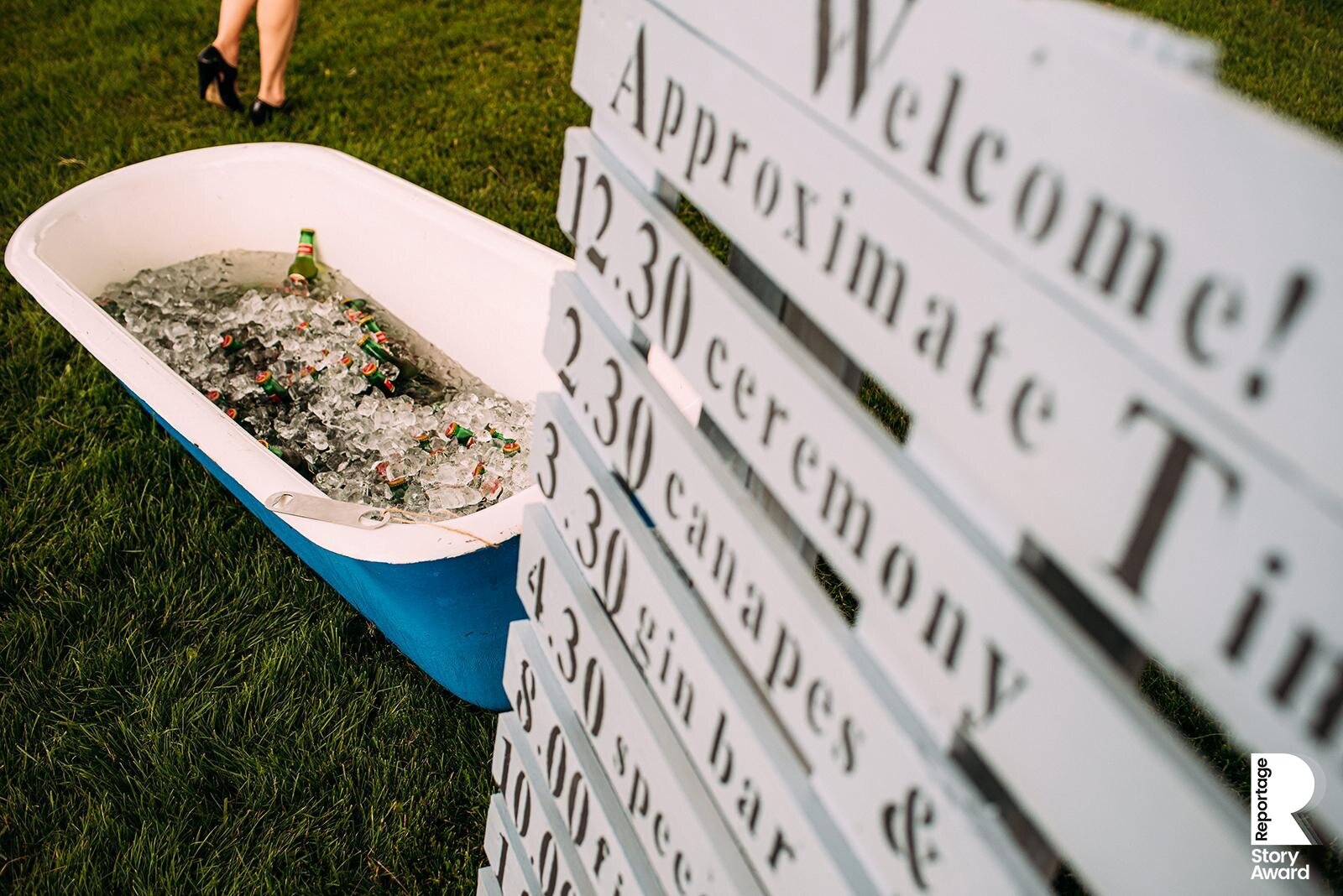  Ceremony timetable with a beer bath and feet in shot. 