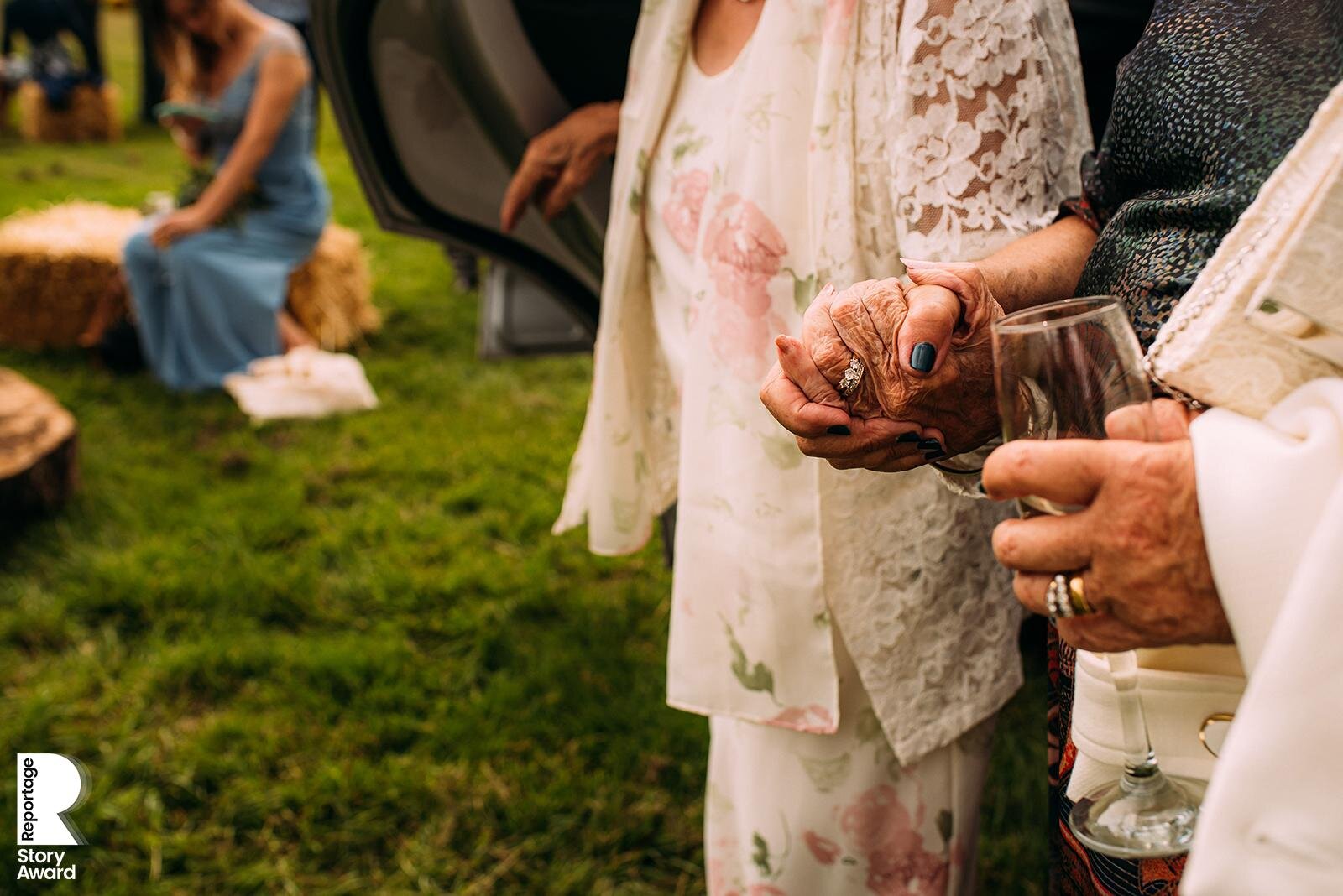  Brides mother holding grandmothers hand. 