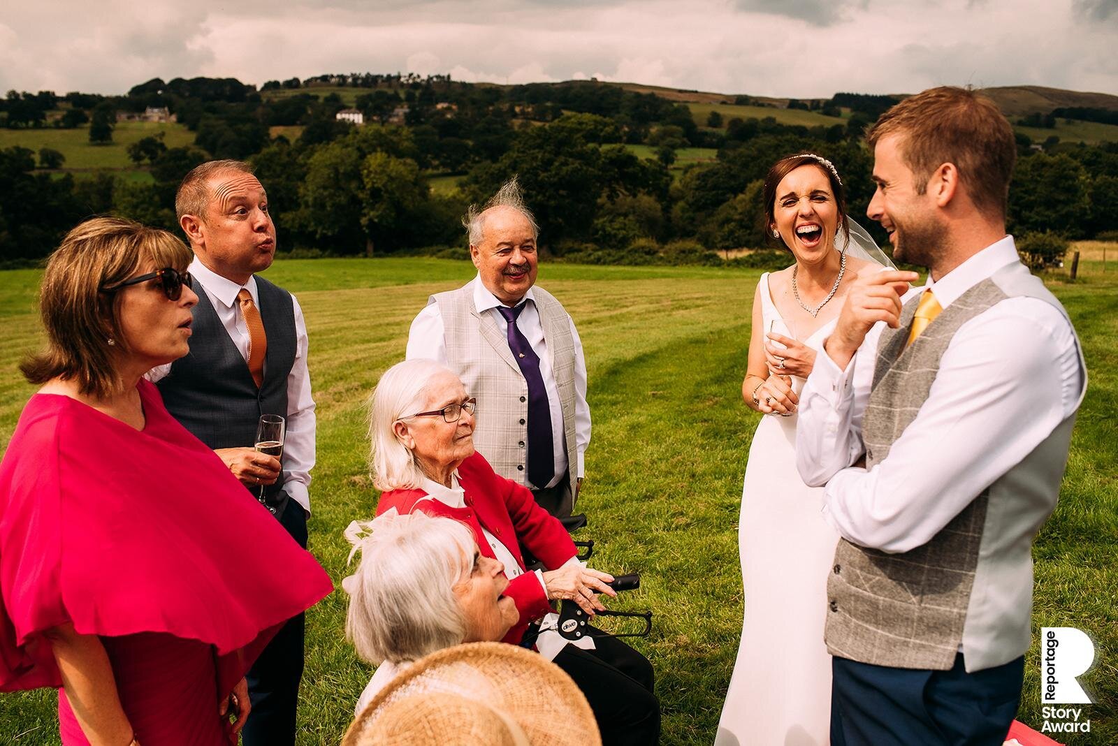  bride and groom laughing with nan and other guests. 