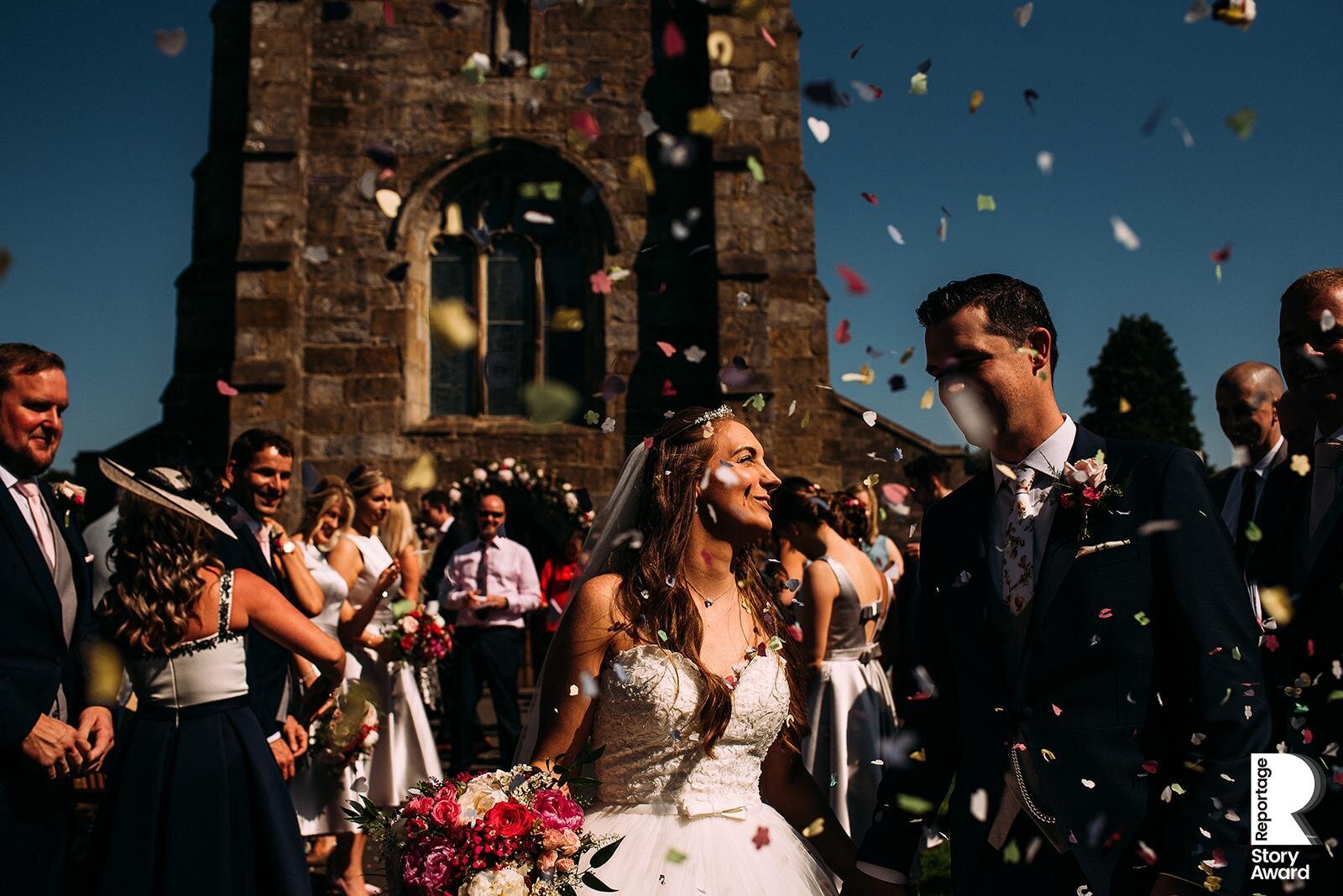  Bride and groom walking out through confetti. 