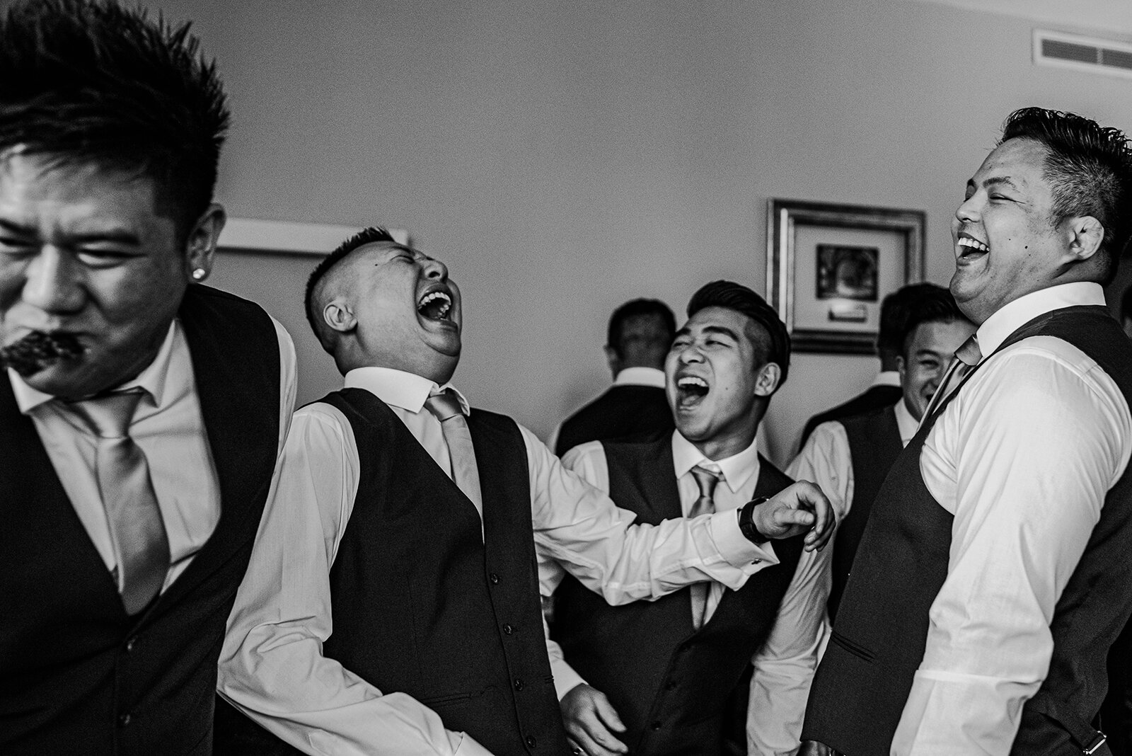 Groomsmen laughing during the Chinese door games.