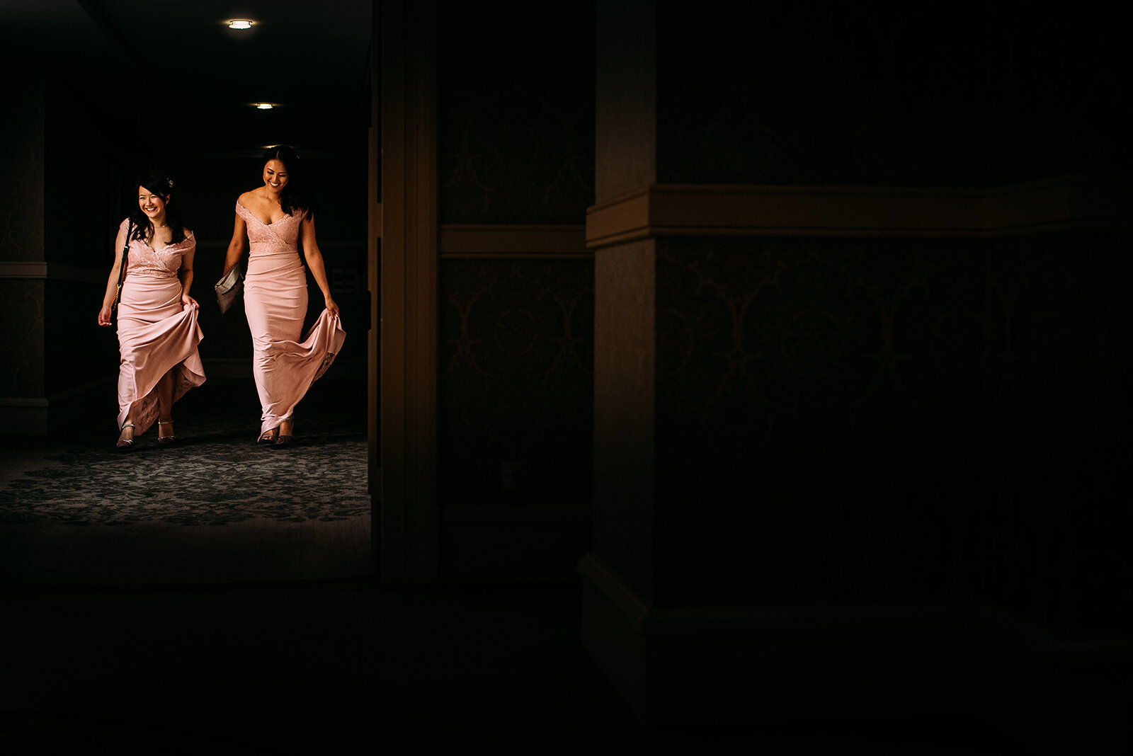 Bridesmaids walking through light.
