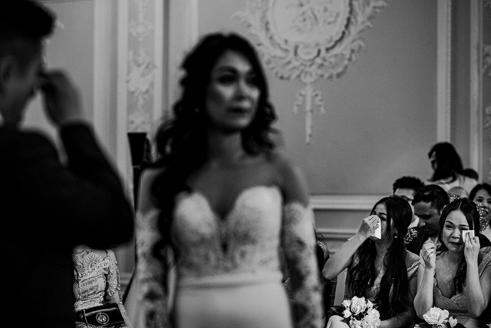 Bridesmaids wiping tears during the wedding ceremony.