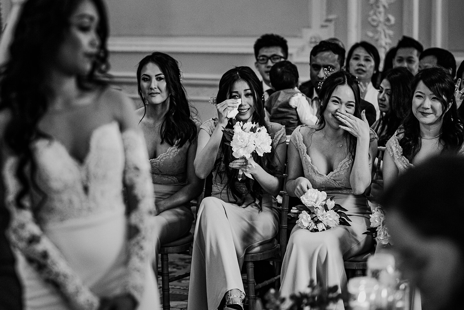 Bridesmaids wiping tears during the wedding ceremony.