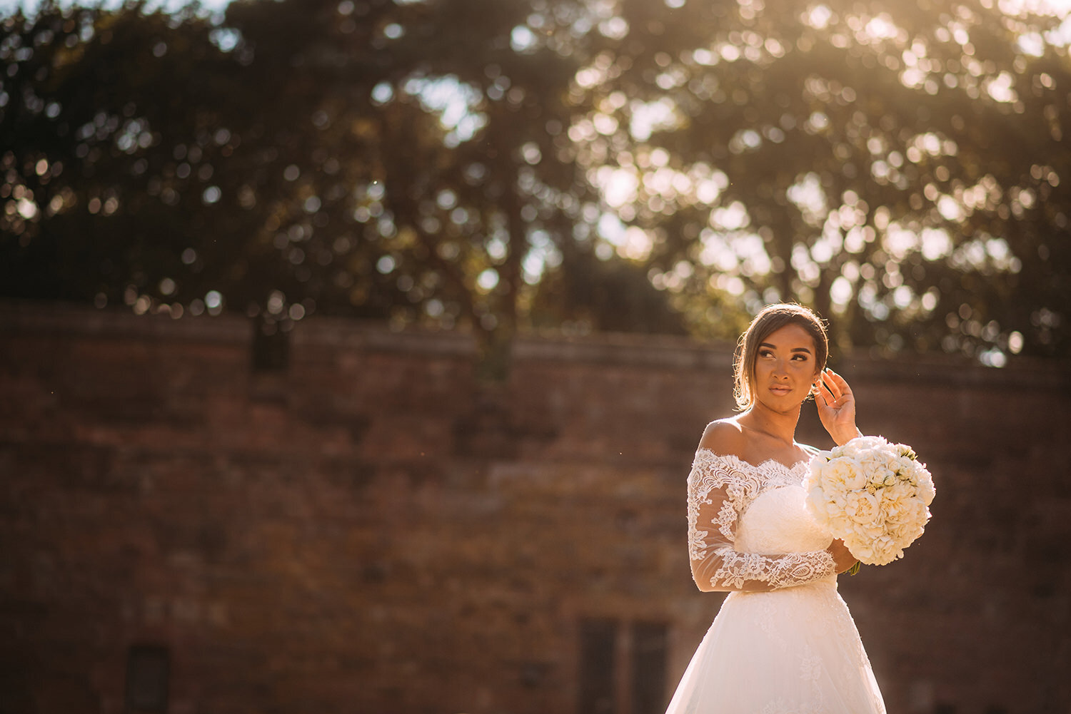  Bride brushes hair past ear in nice light 