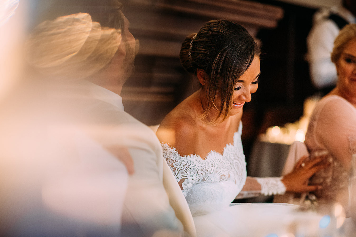  Bride laughing during her husbands speech 