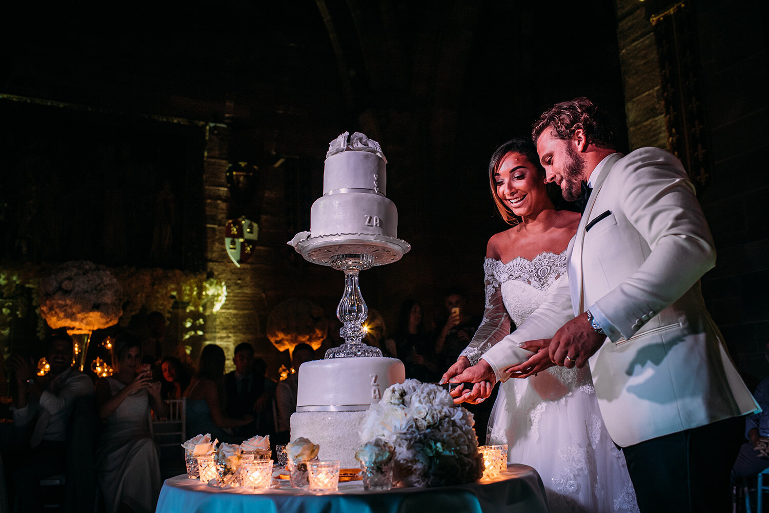  Bride and groom cut the cake in the great hall. 