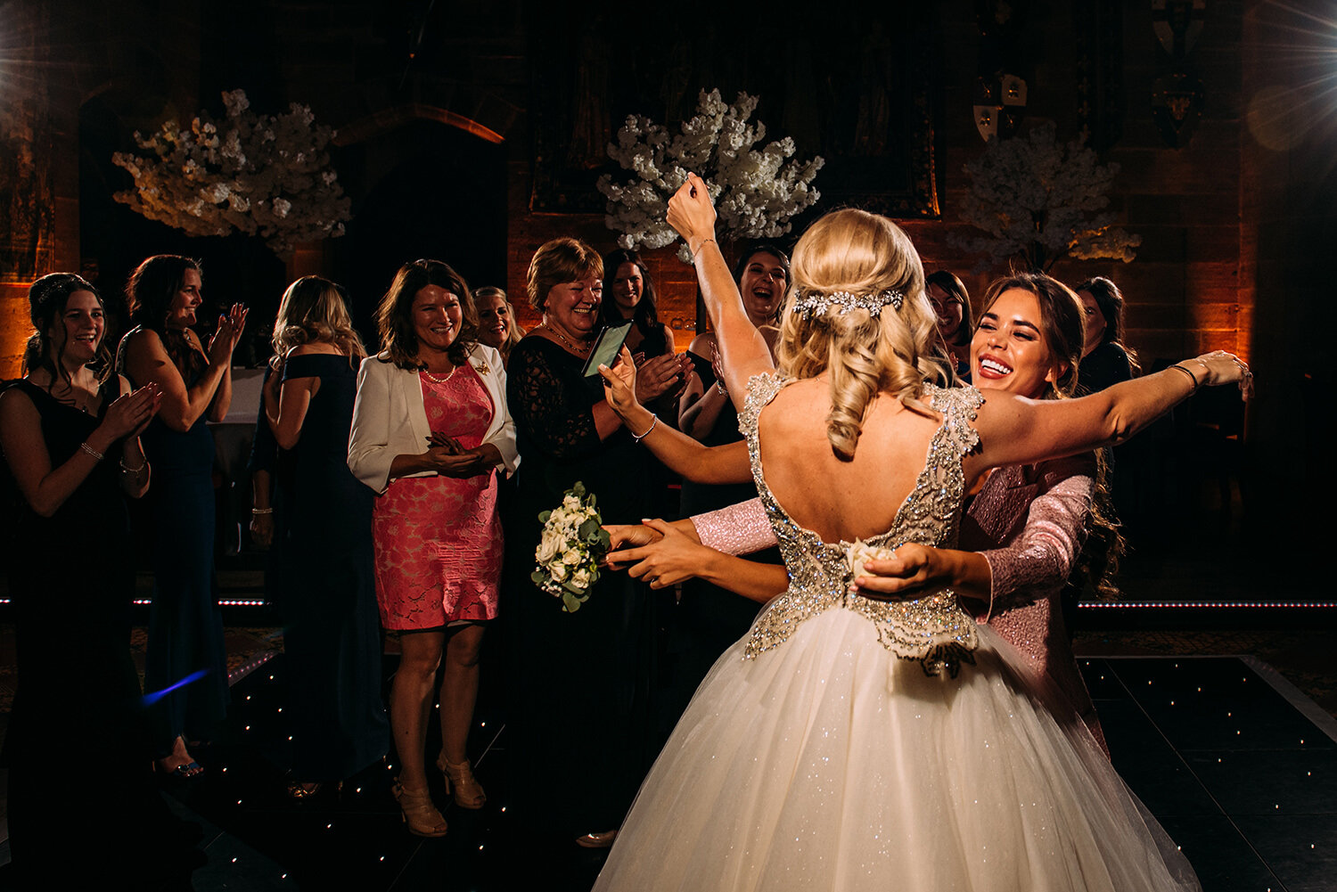  Bride hugs friend after she catches the bouquet 