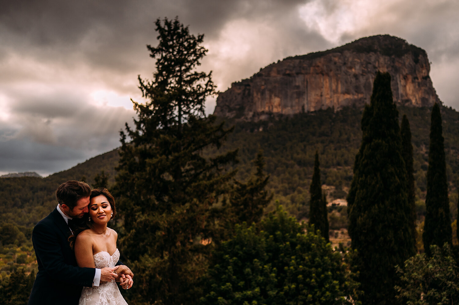  Couple shot in front of mountain in Mallorca. 