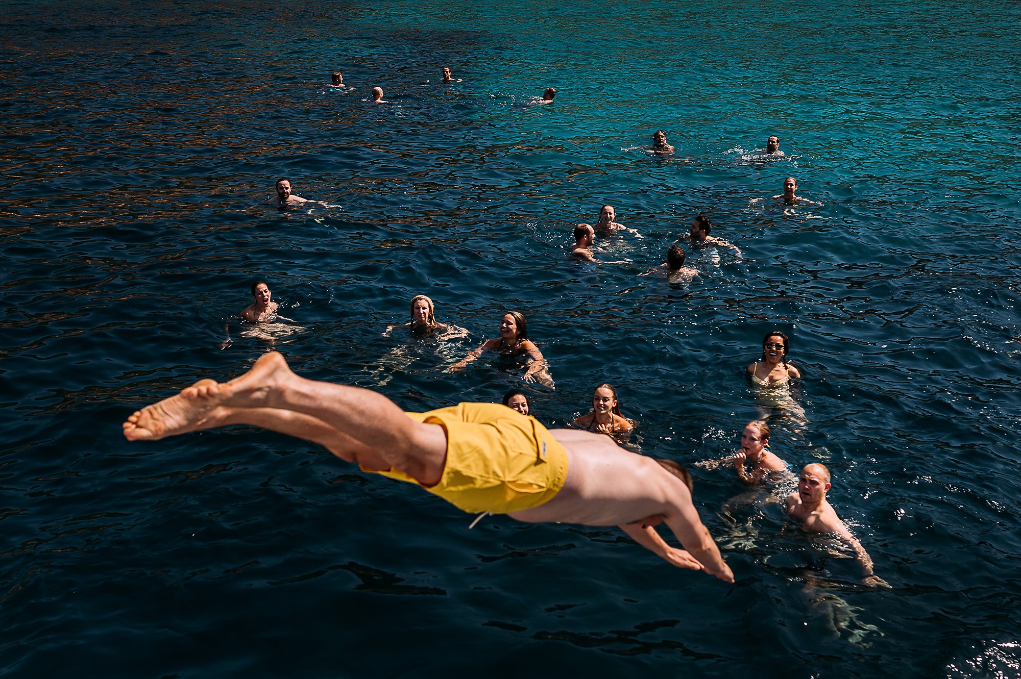  Guests diving off a boat into the sea 