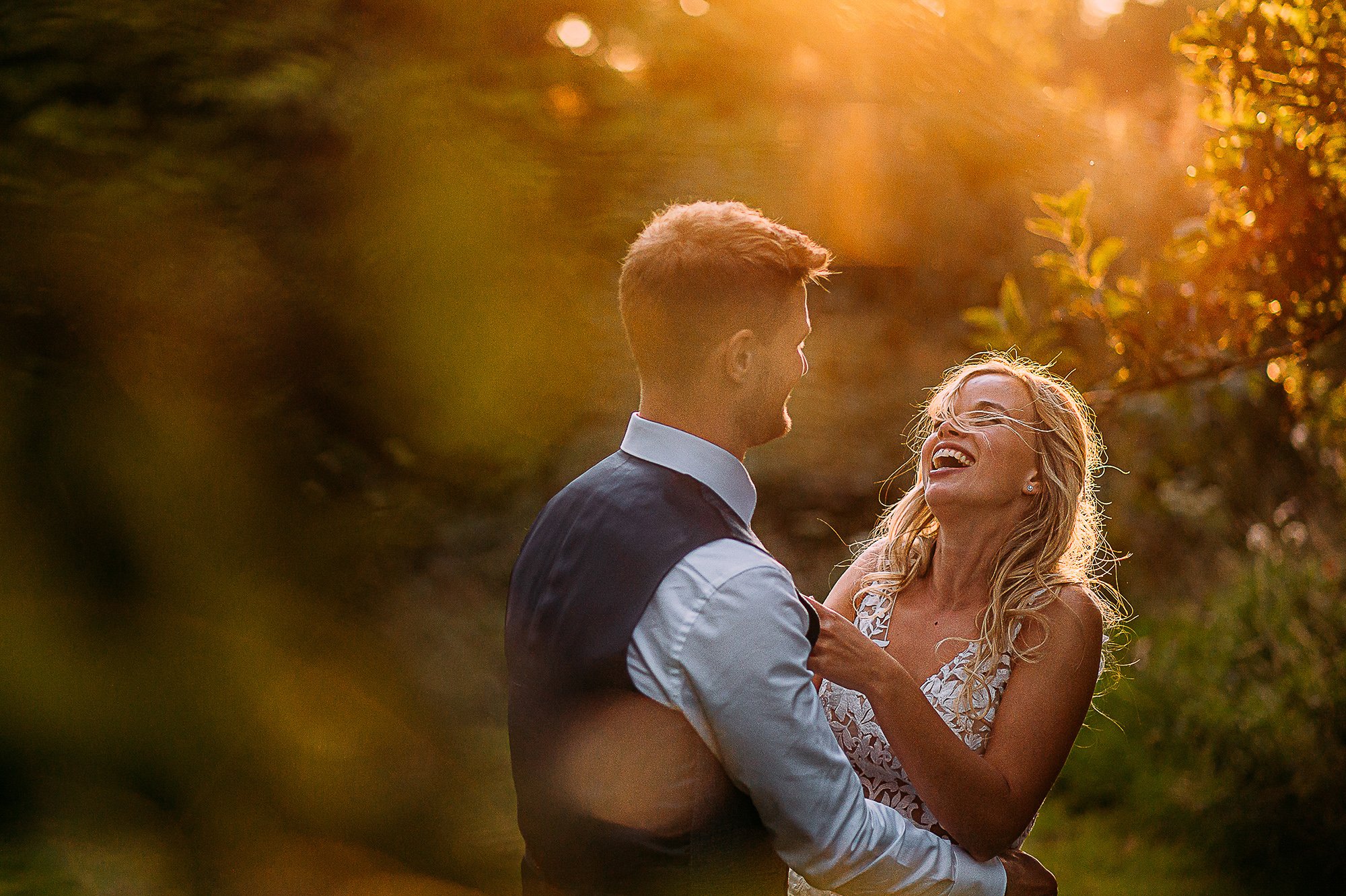  Couple portrait with the bride laughing during sun set. 