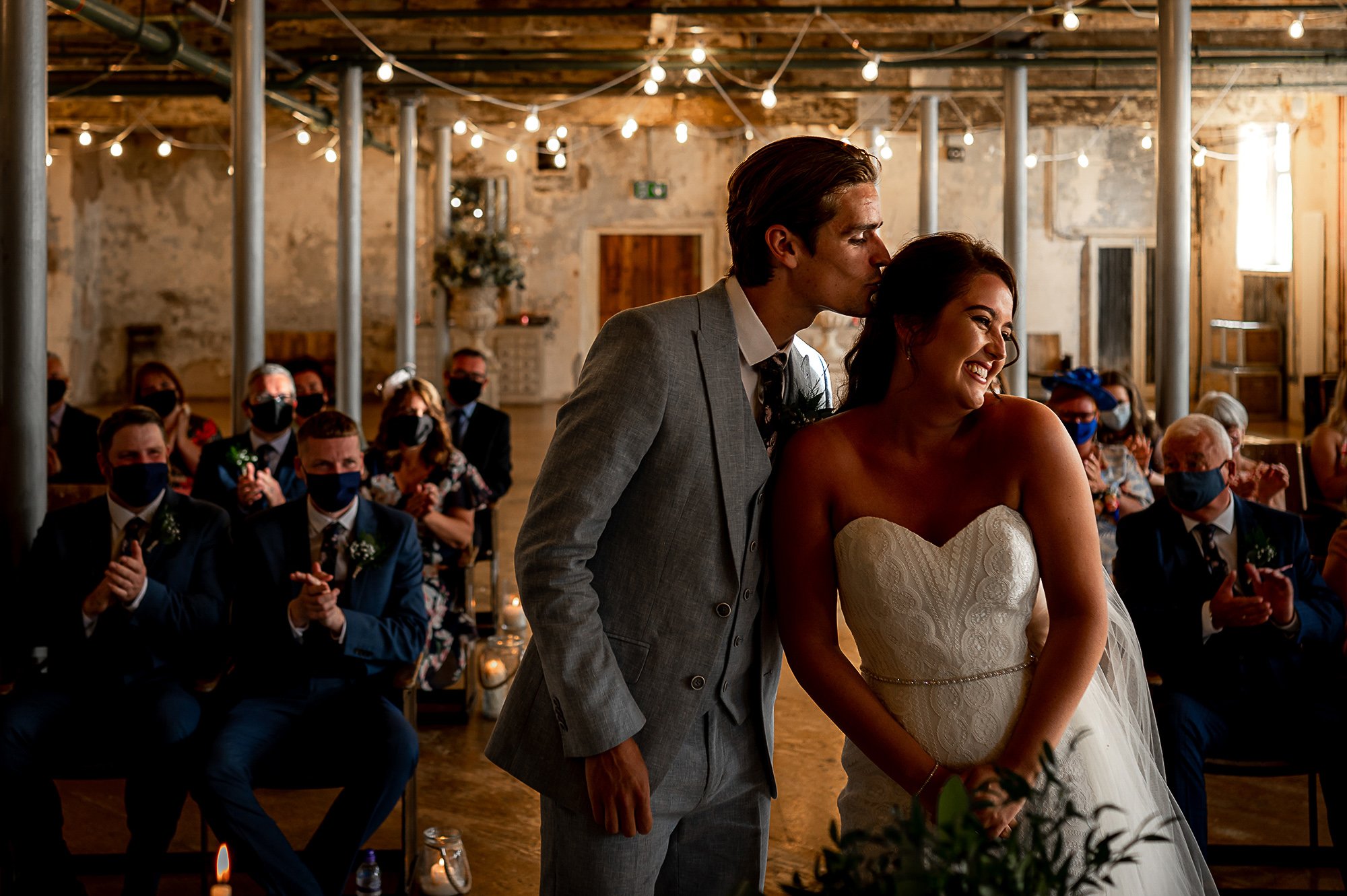  Groom kisses bride as she enters the ceremony at Holmes mill. 