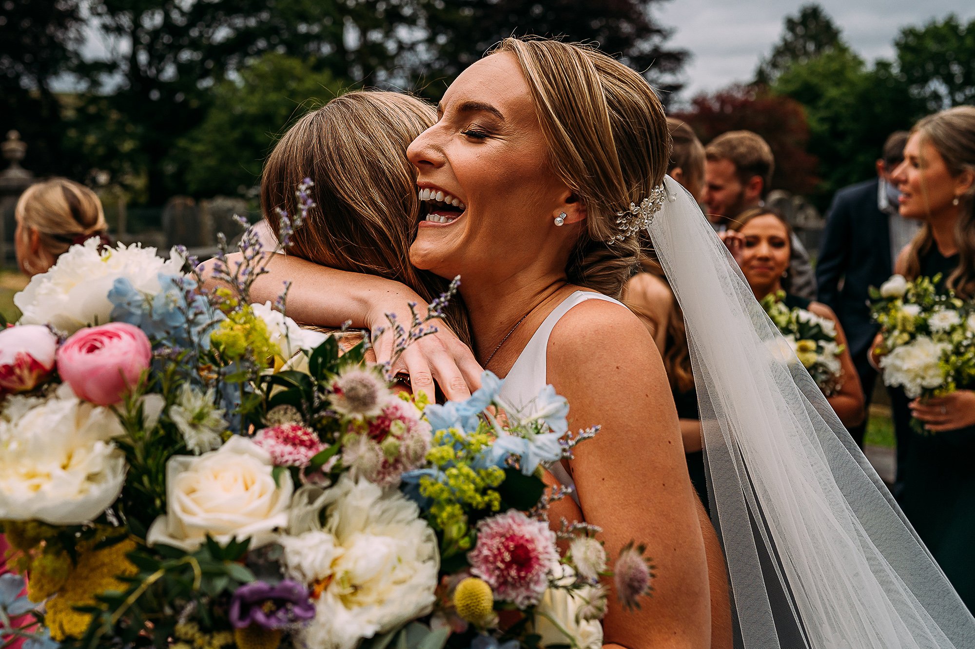  Bride hugs her friend after getting married. 