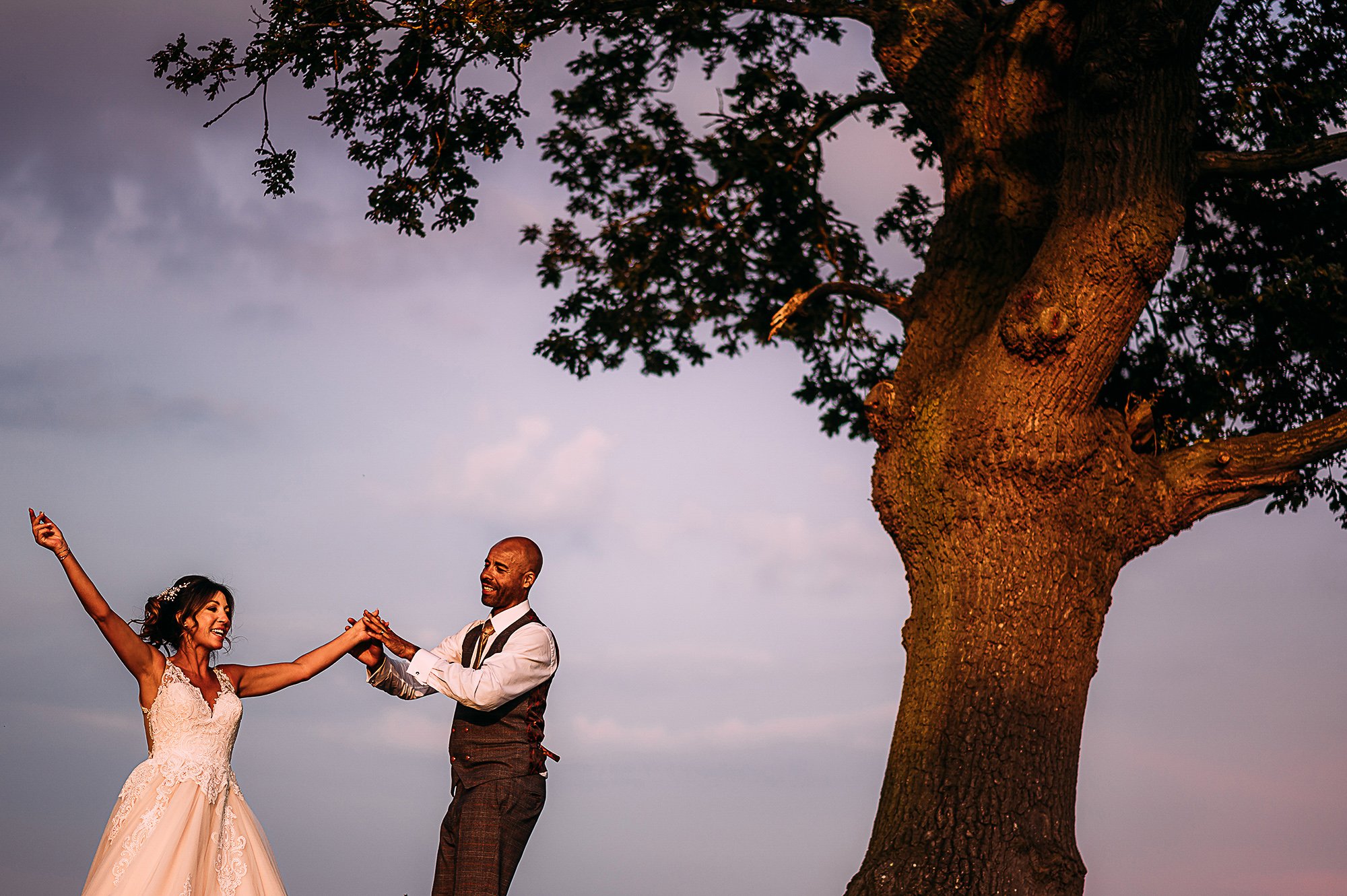  Happy bride and groom under a tree. 
