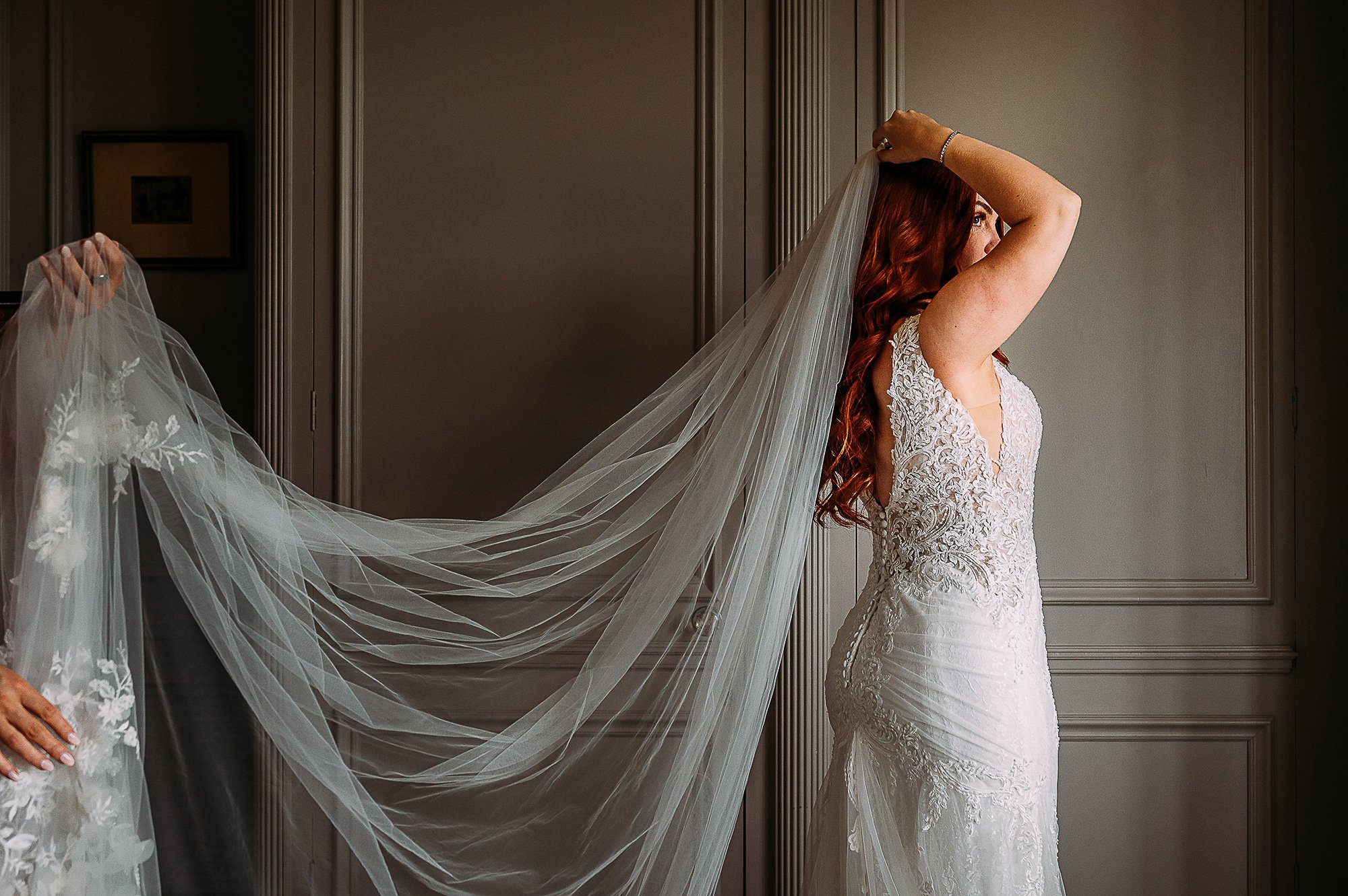 Bride adjusting her veil at Thornton Manor. 