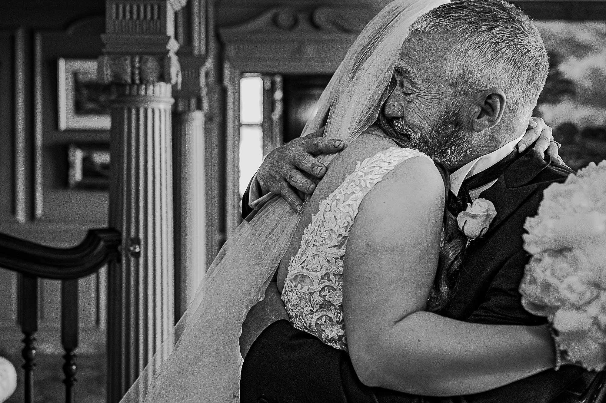  Emotional father of the bride hugging his daughter. 