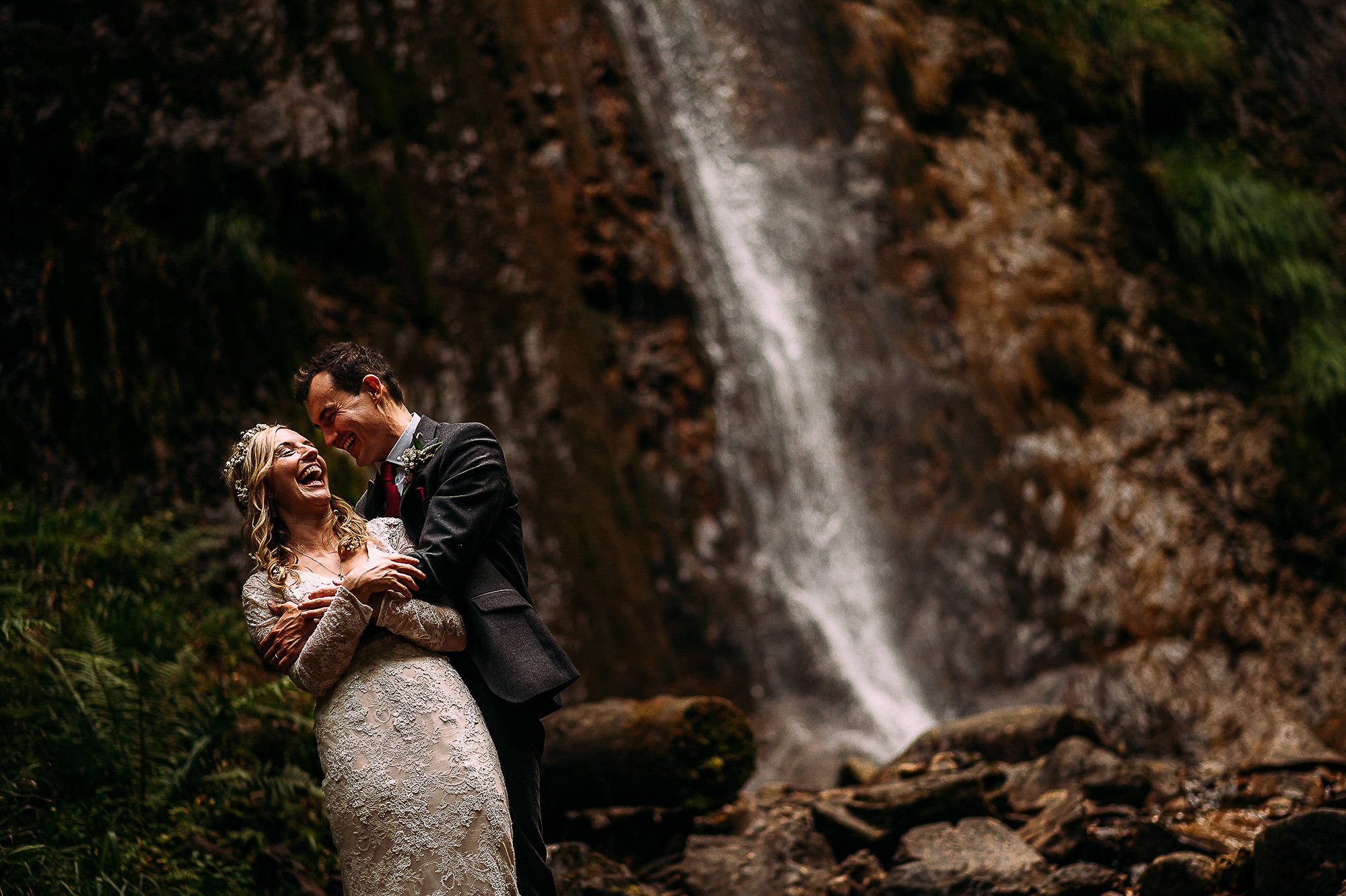  Couple in front of a waterfall in Wales. 