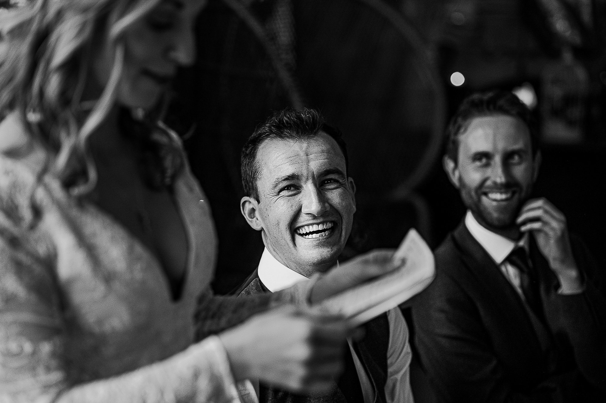  Groom smiling at his wife during her speech. 