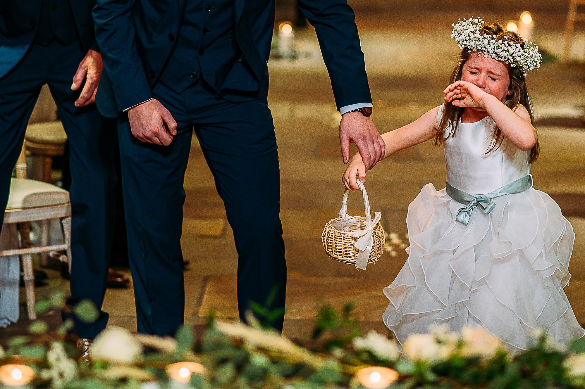  Flower girl crying as she walks down the aisle. 