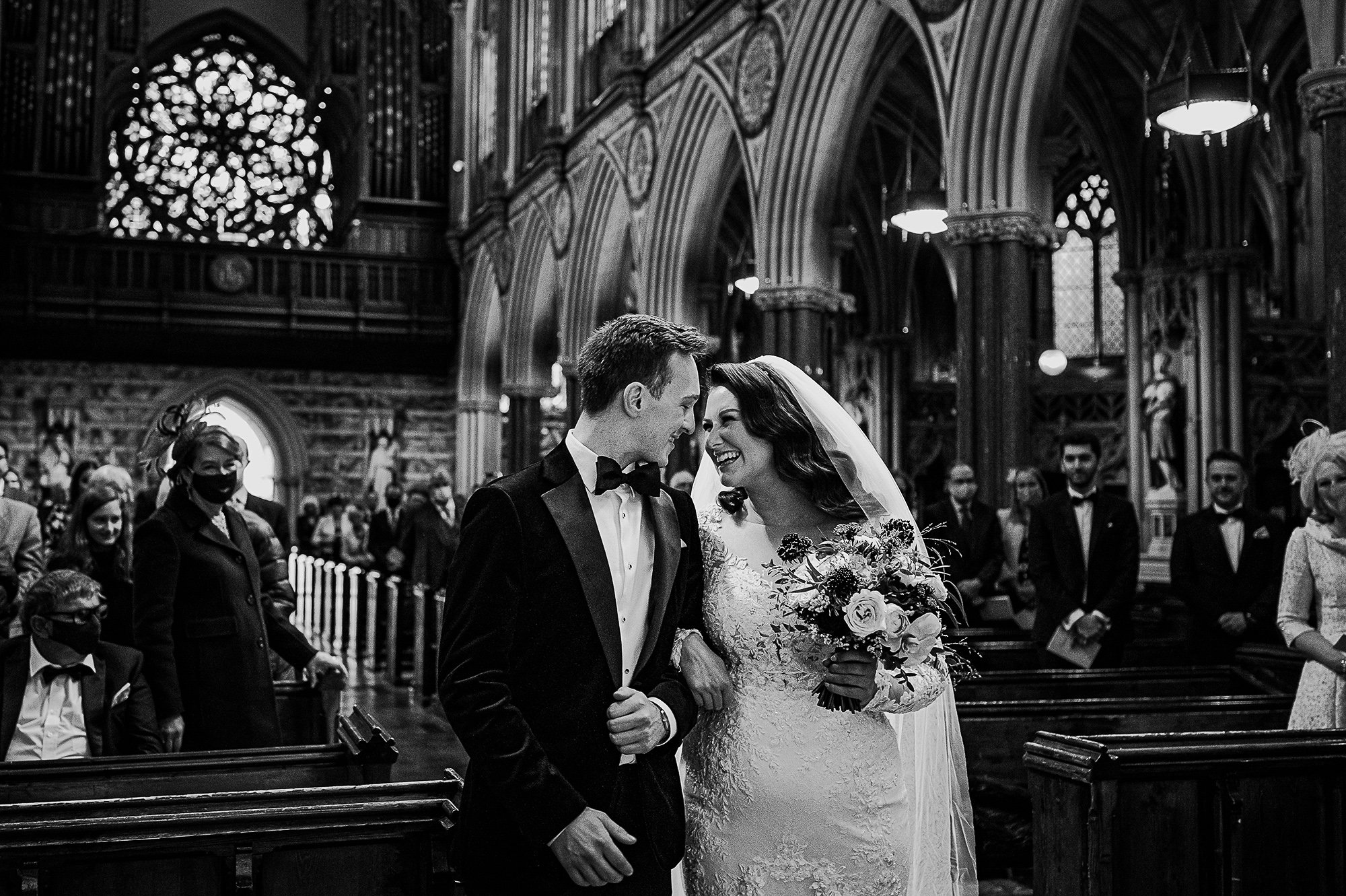  Bride and groom smiling in church. 