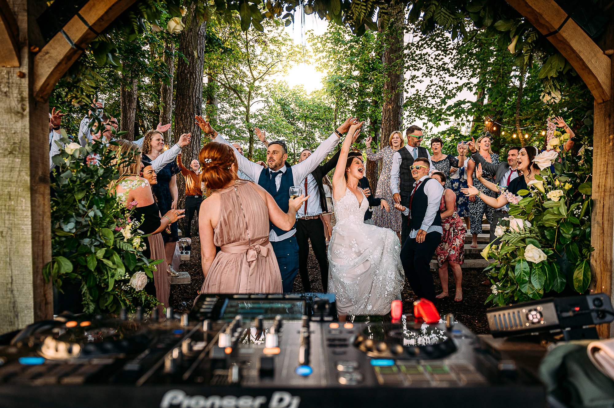  Outdoor wedding rave in the woods taken from behind the DJ decks. 