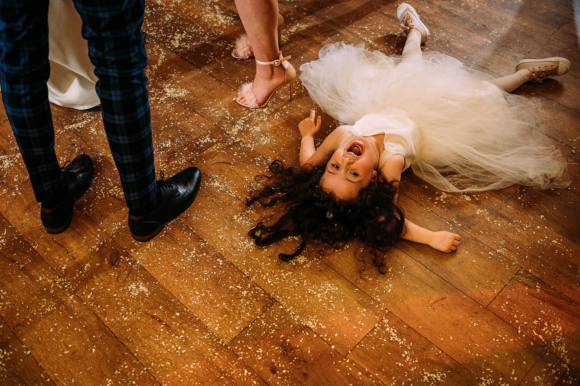  Flower girl doing a ‘snow angel’ in confetti on the floor. 