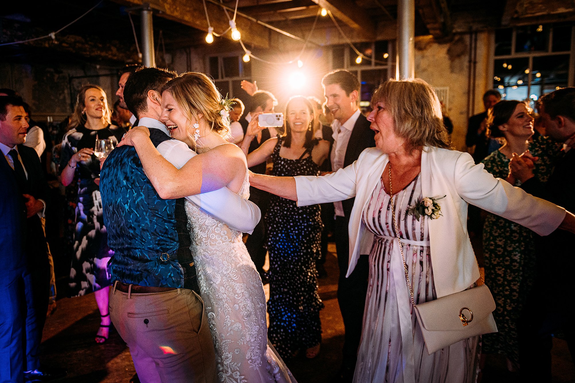  Grooms mum reaches out to the couple at the end of their first dance. 