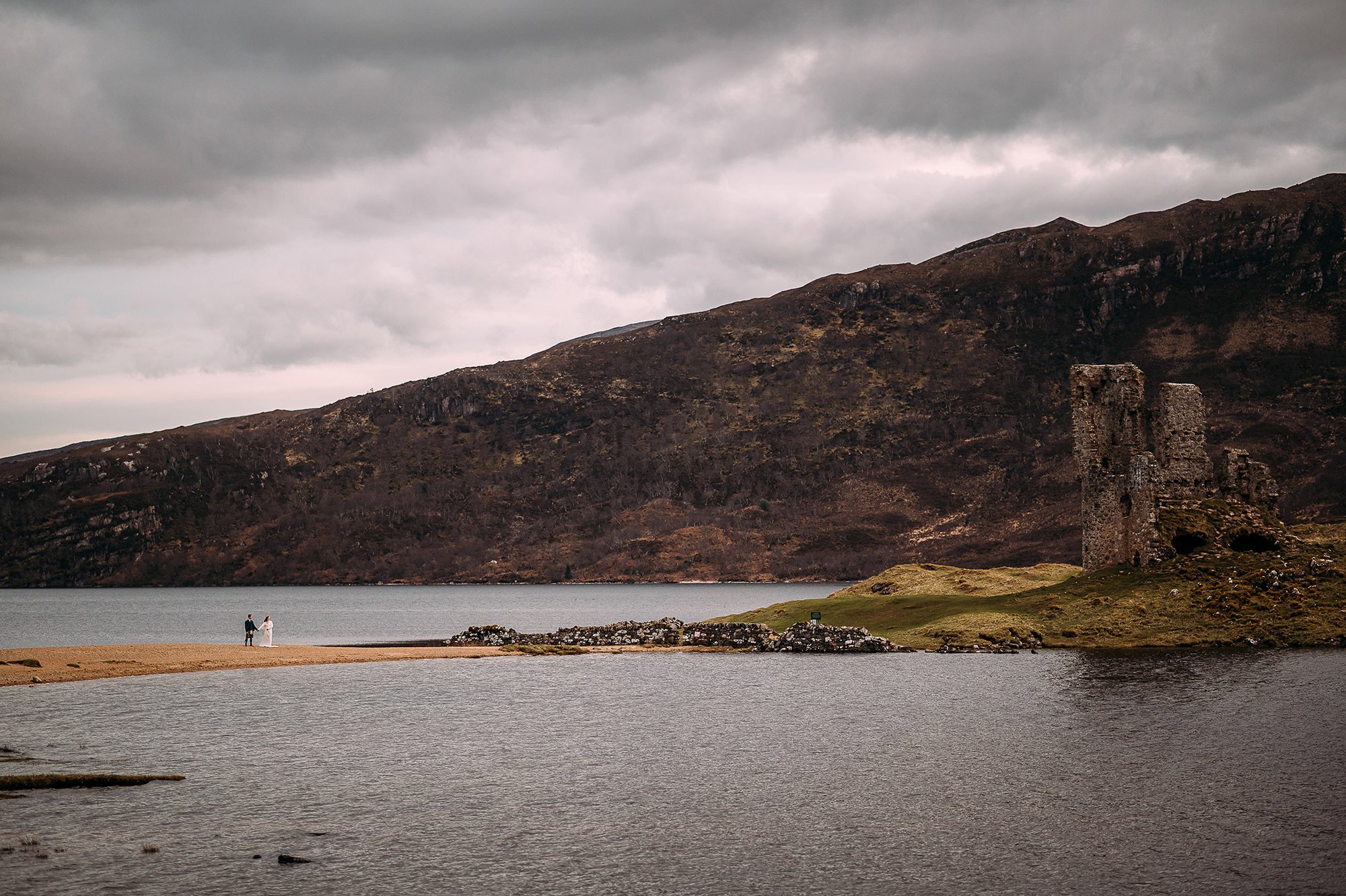  Couple walking through the stunning scenery of the Scottish highlands. 