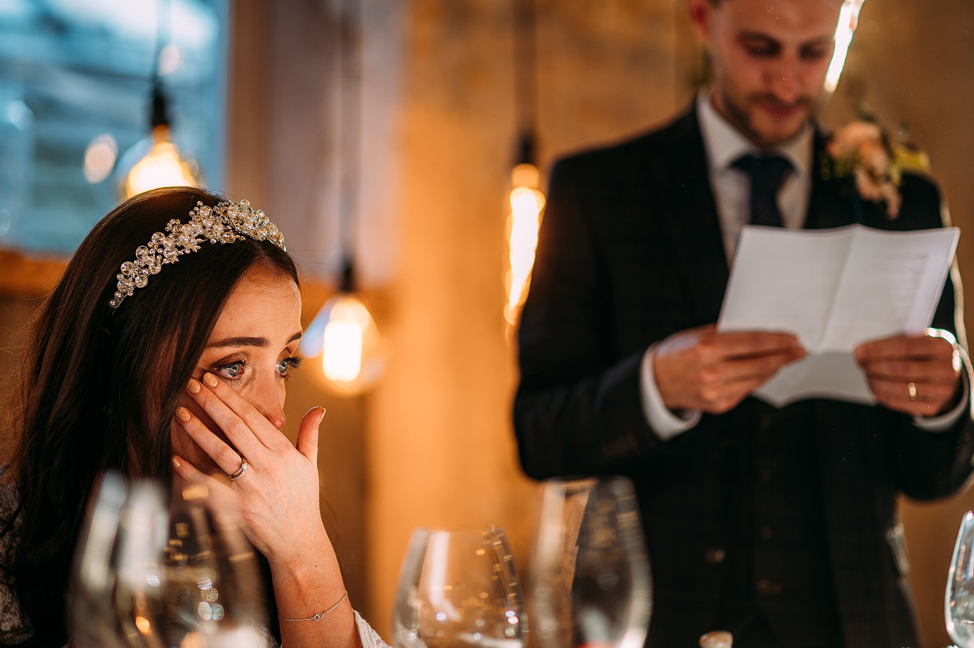  Brides eyes filled with tears. She wipes one during her husbands speech. 