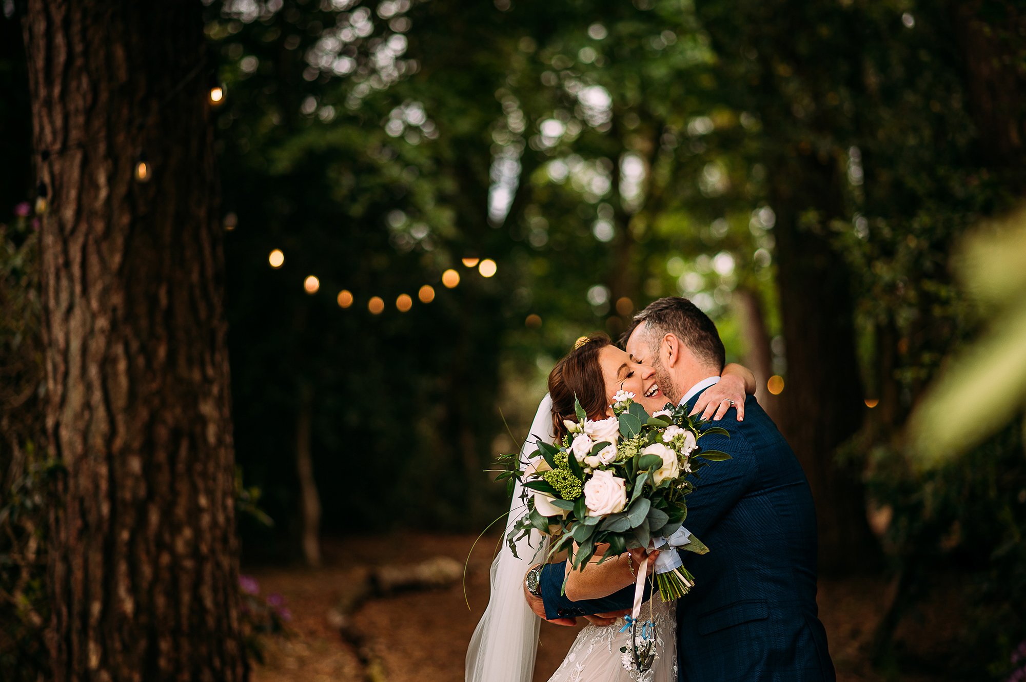  Couple hug after just getting married in the woods. 
