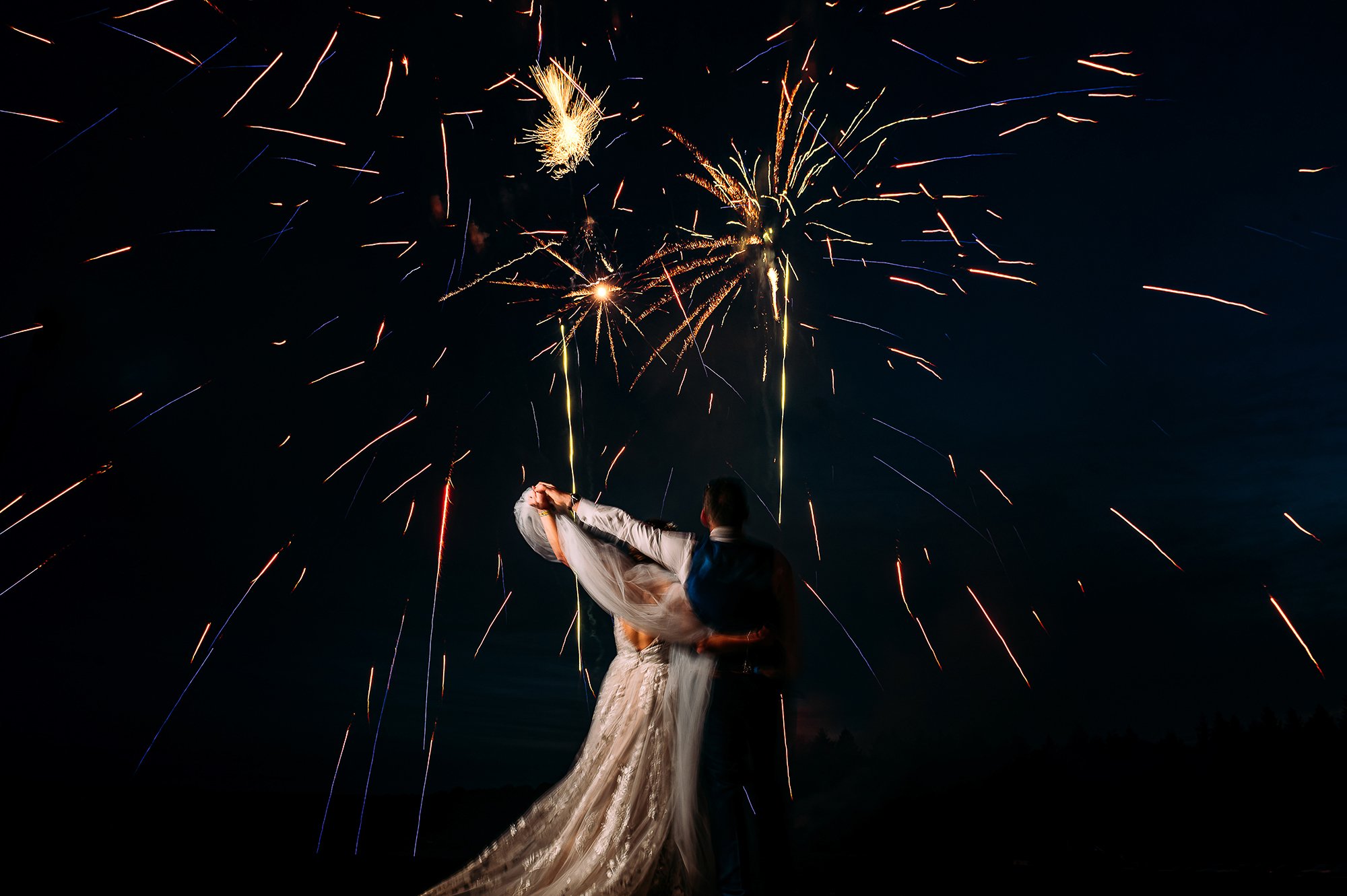 Couple watching fireworks at wedding. 