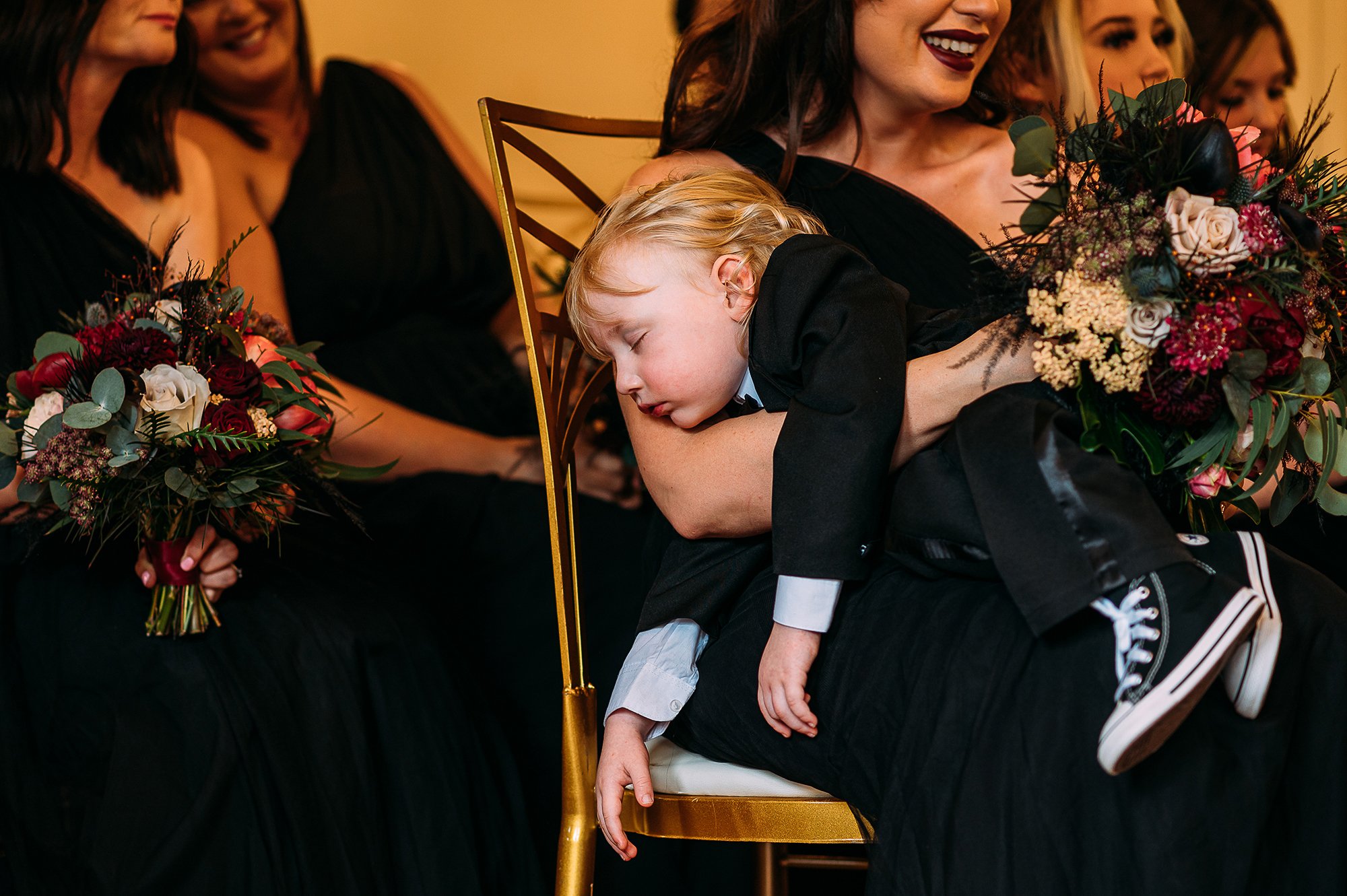  Boy falls asleep on someones arm during ceremony. 