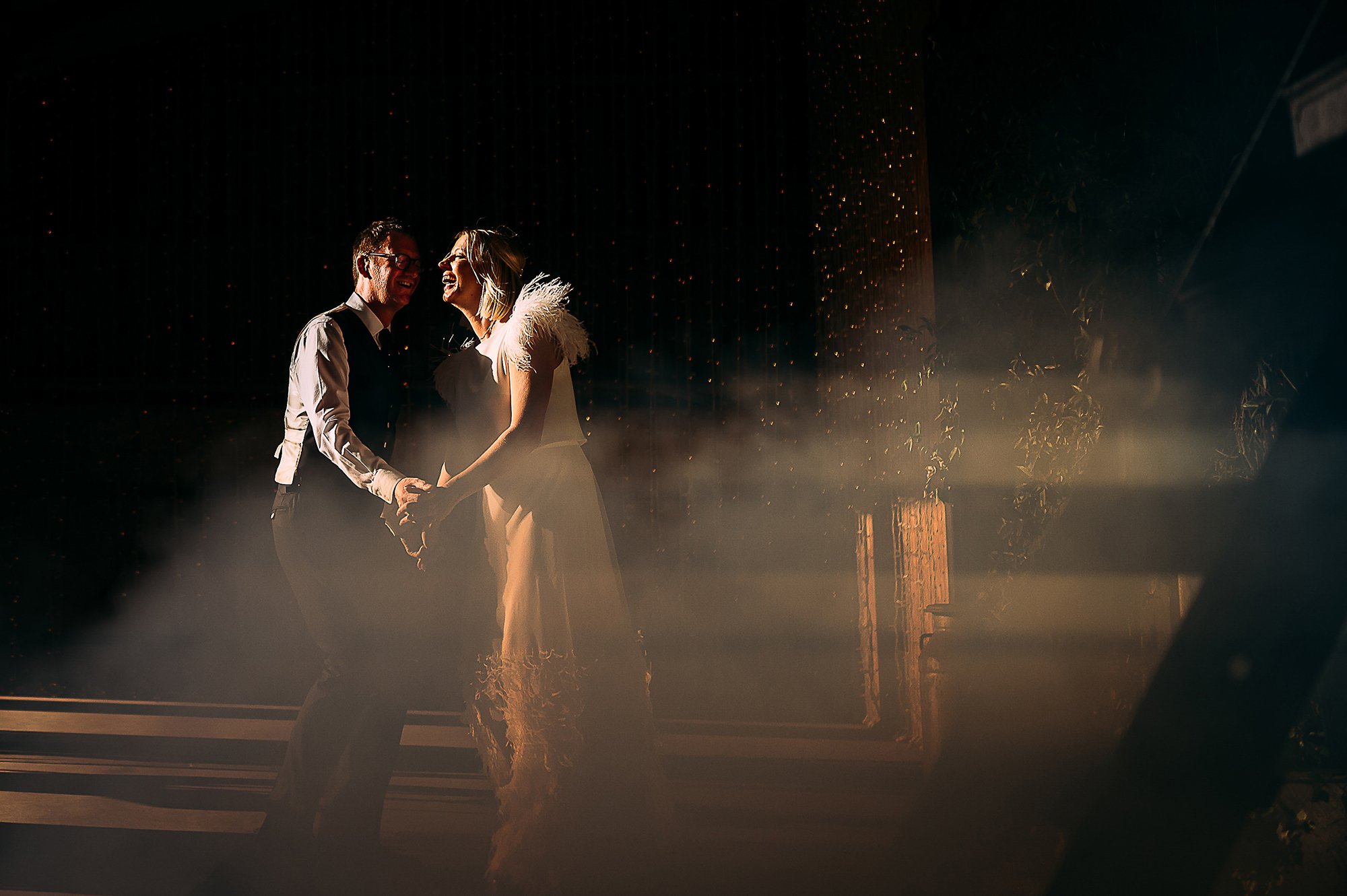  Couple dancing in sunlight and smoke. 