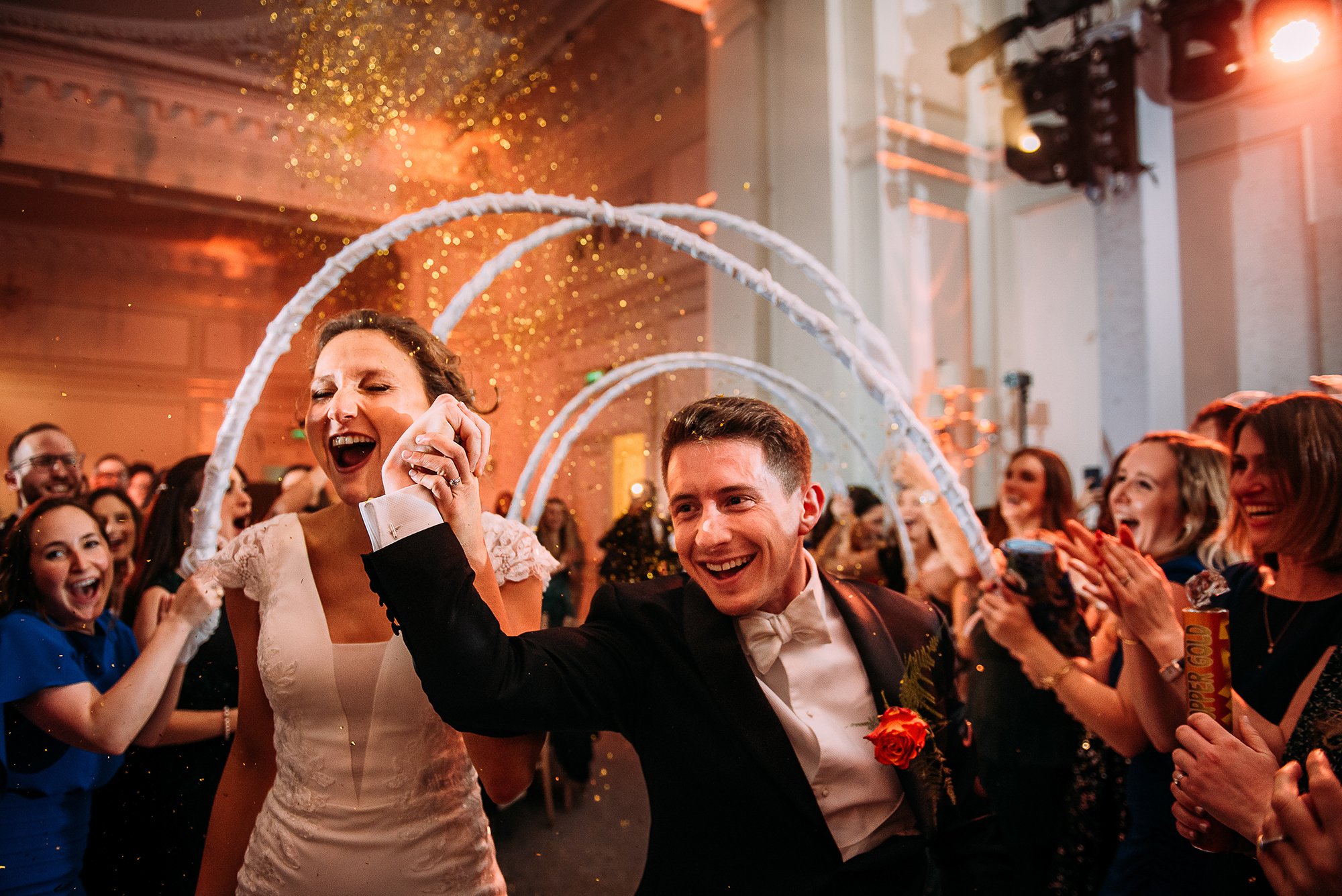  Couple run through hoops at a Jewish wedding 