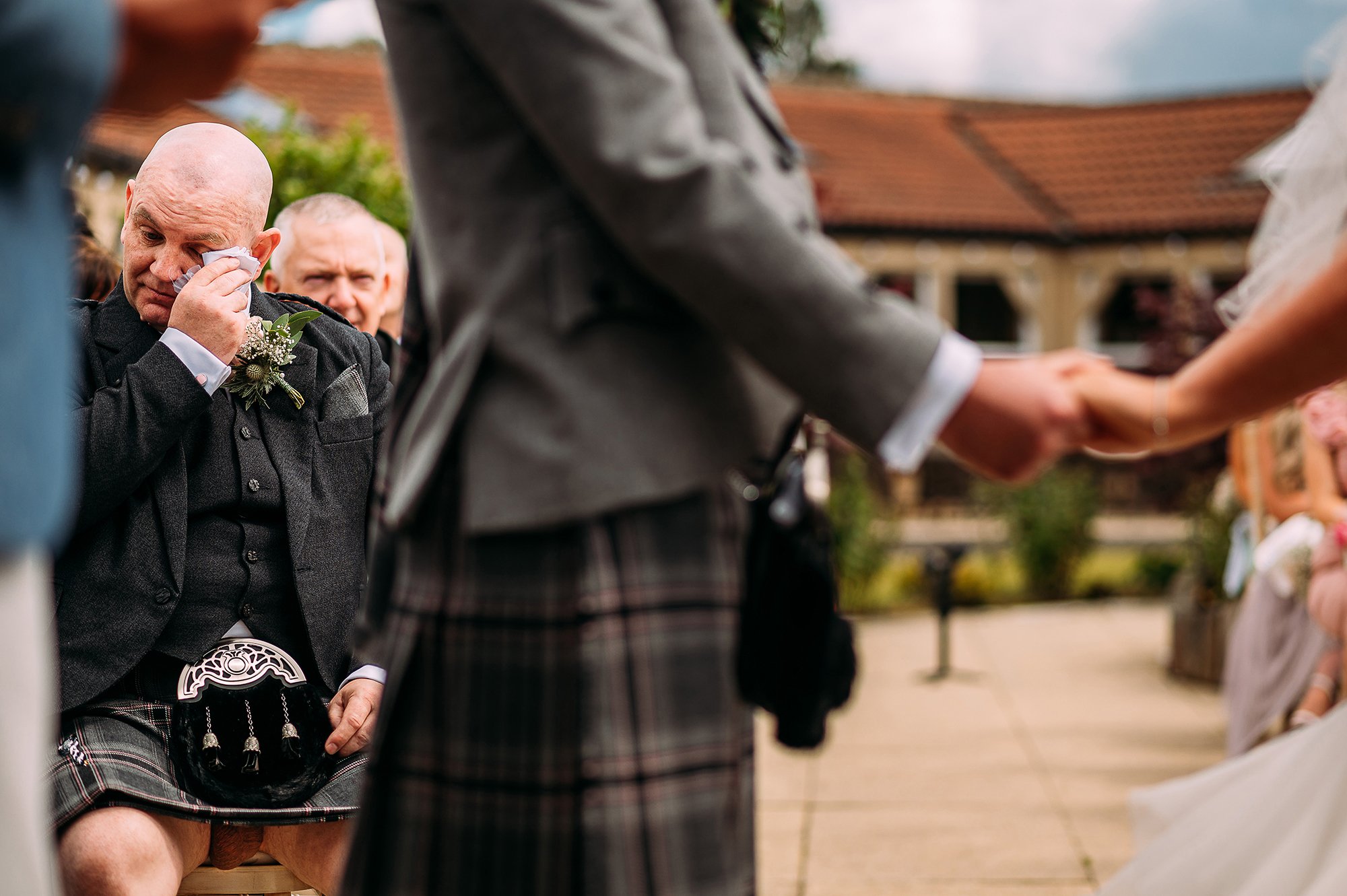  Grooms dad wiping tears during ceremony whilst also showing what’s under his kilt. 