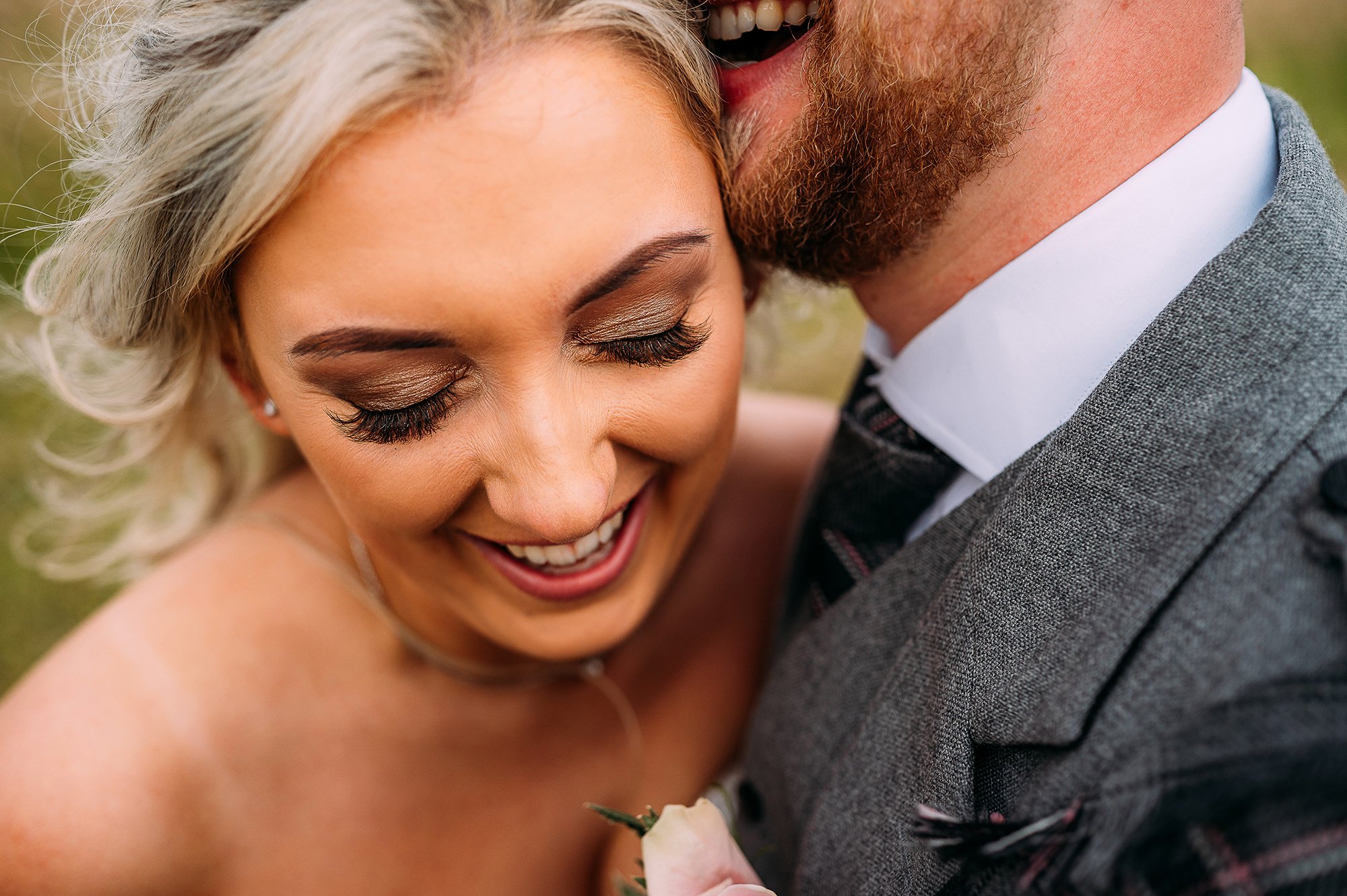  close up couple portrait, bride laughing, grooms mouth just in shot making her laugh. 