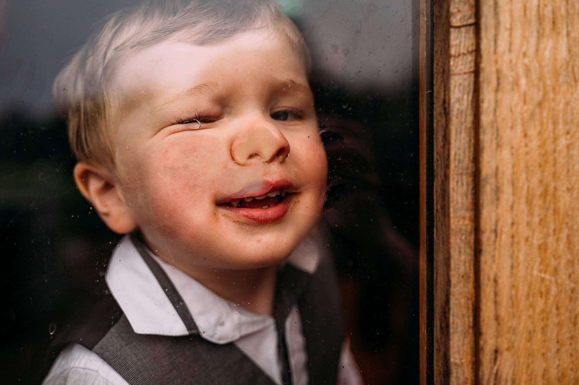  child squashing his face up against the window. 