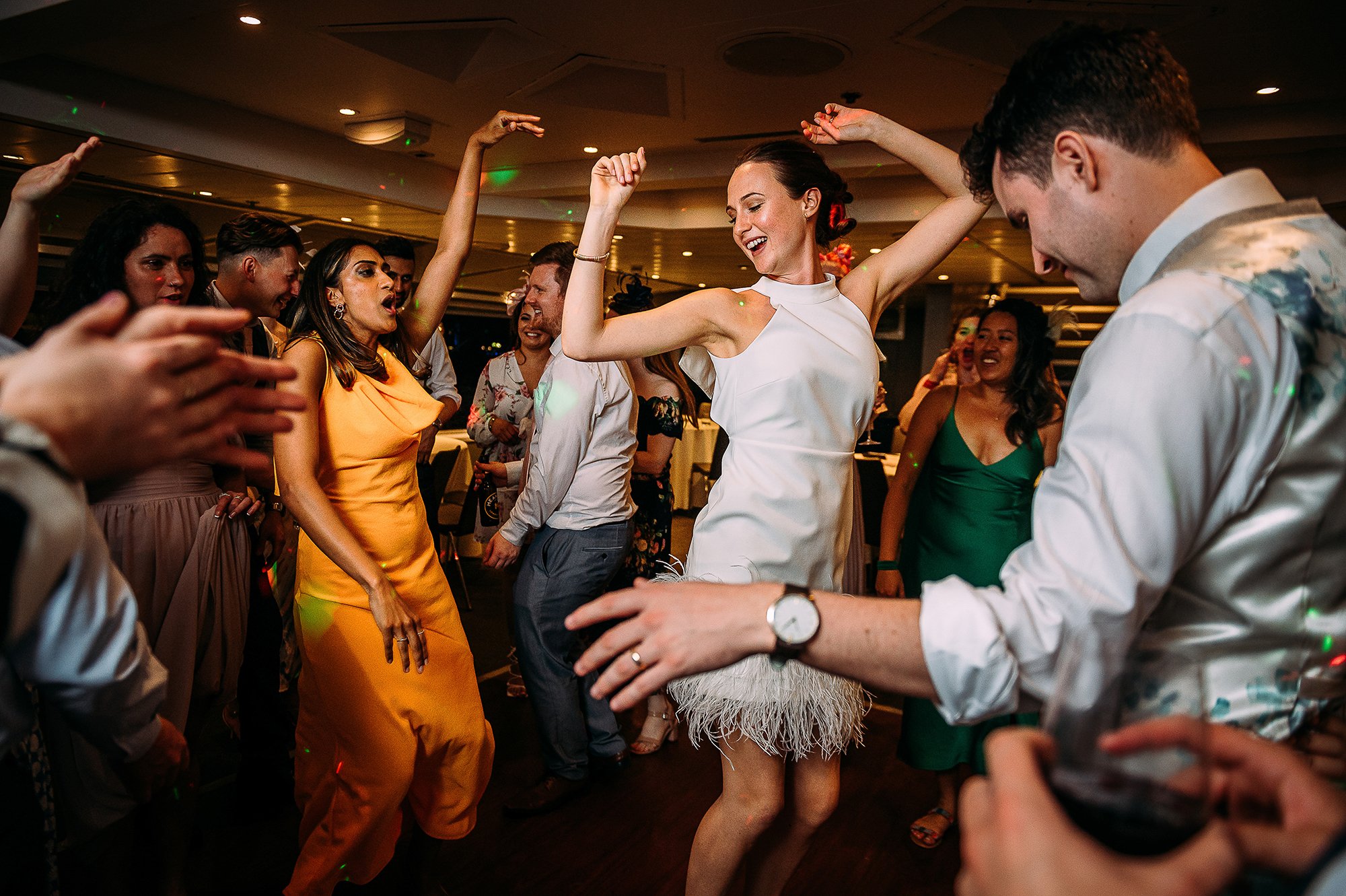  Everyone dancing with bride in the centre of the image. 