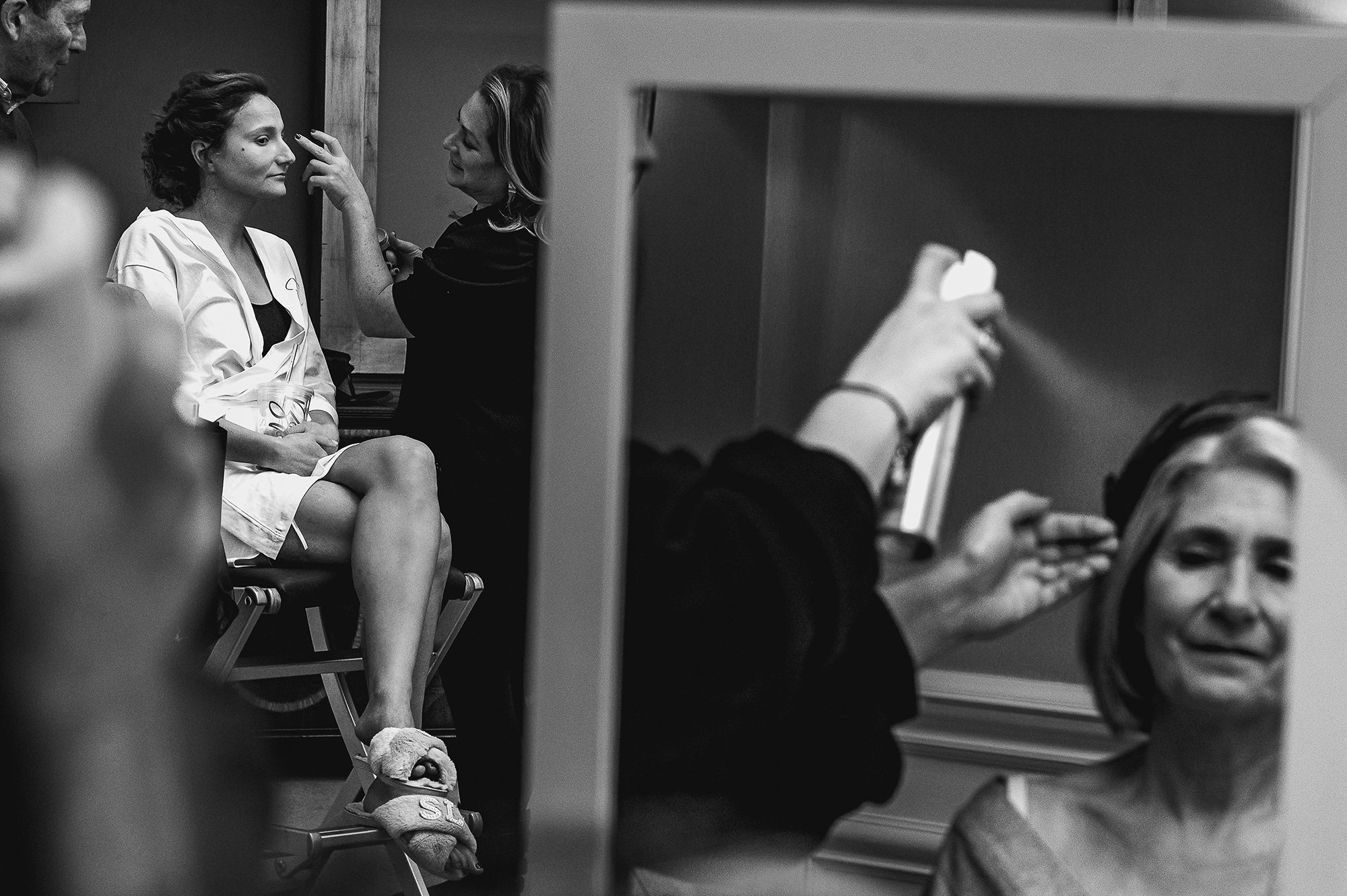  Bride having make up done to the left while a reflection of her mum on the right. 