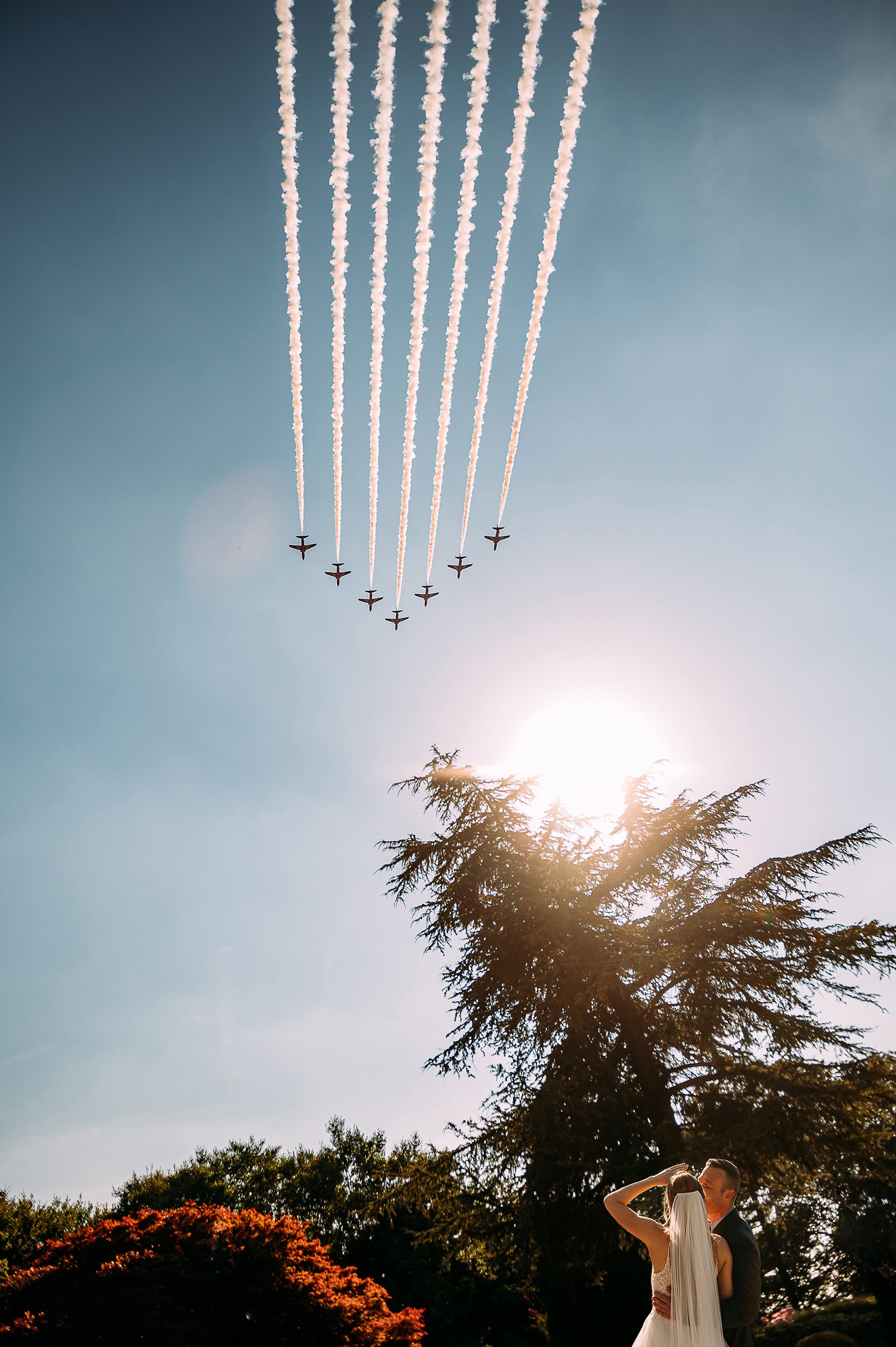  Red arrows flying over the bride and groom at Eaves hall. 