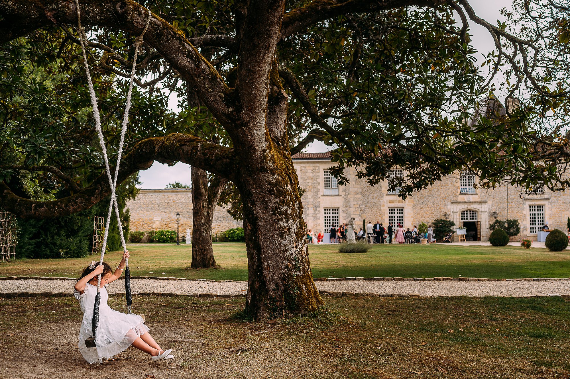  Girl on a swing outside the chateau venue in France. 