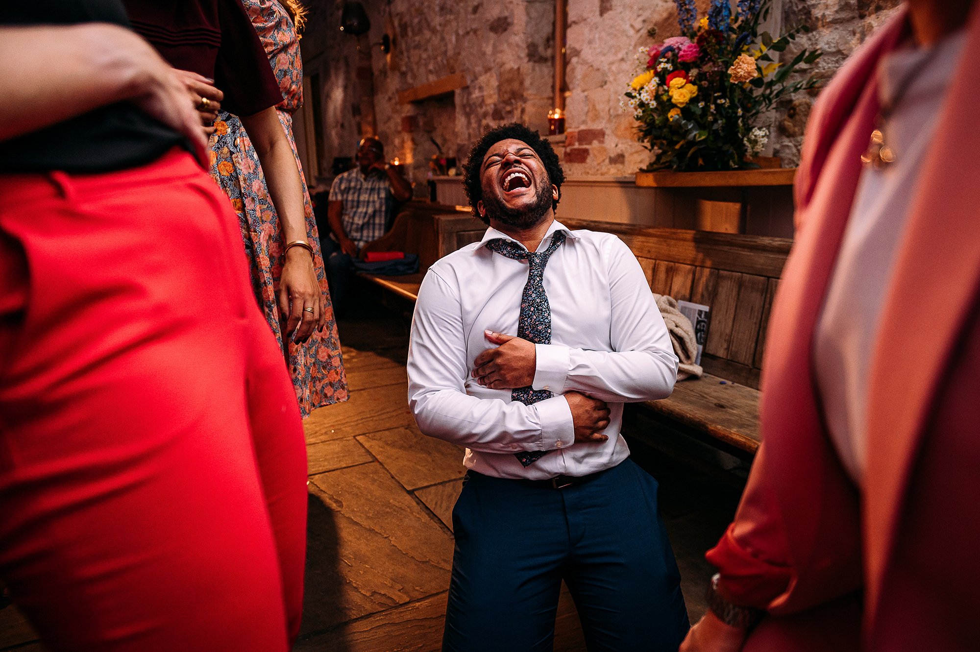  Guest on his knees laughing on the dance floor. 