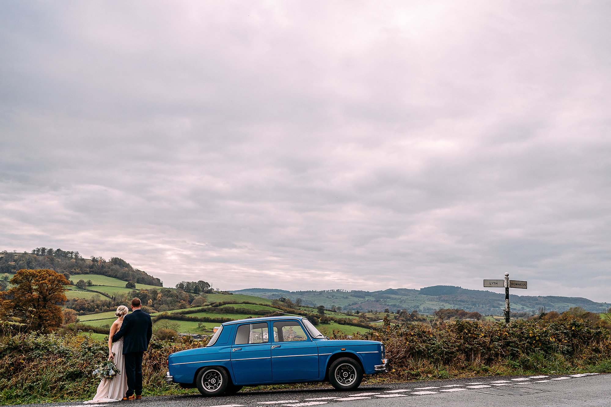  Couple by their car taking in the scenic views. 