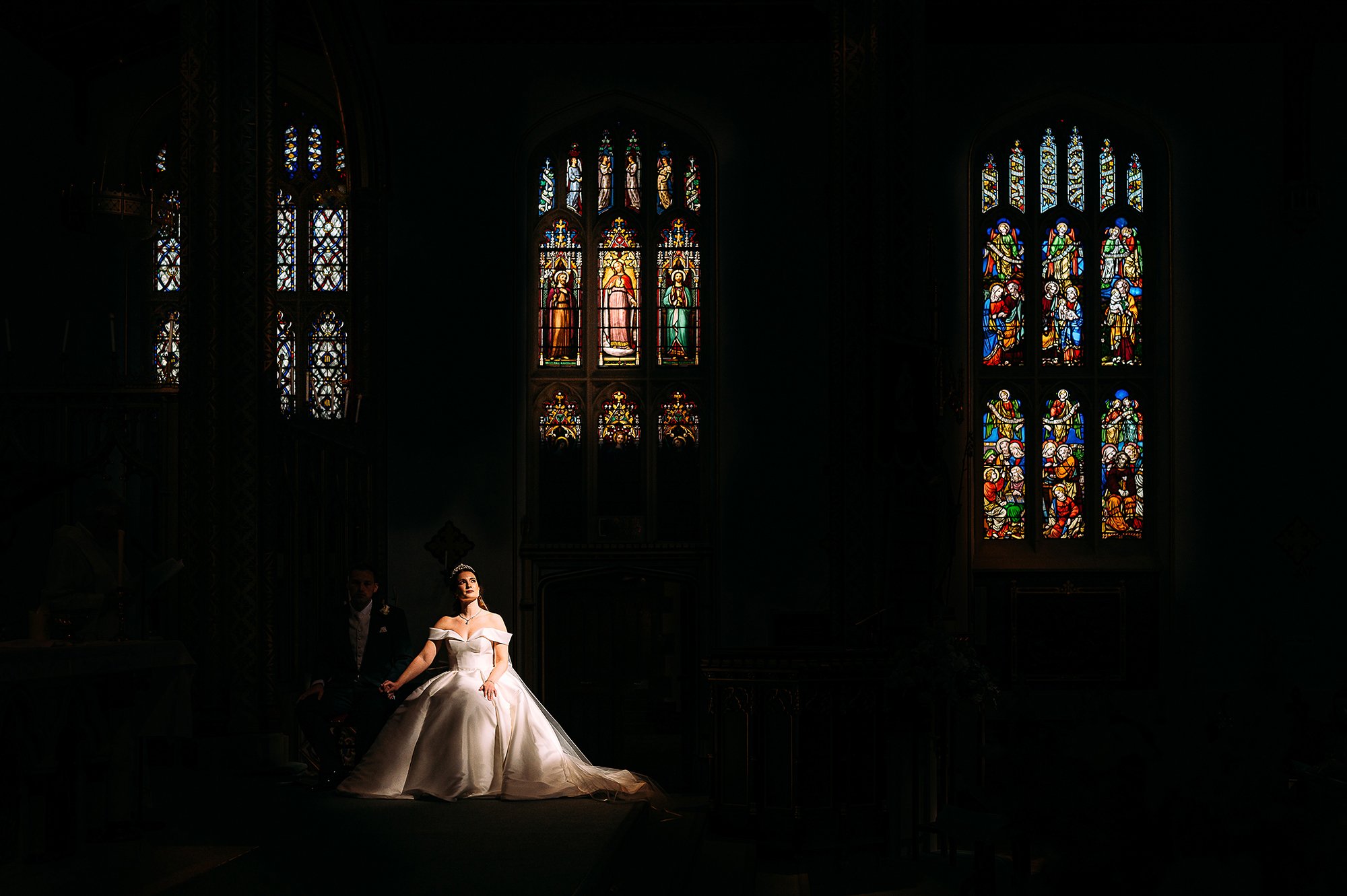  Bride sat in incredible light in church. 