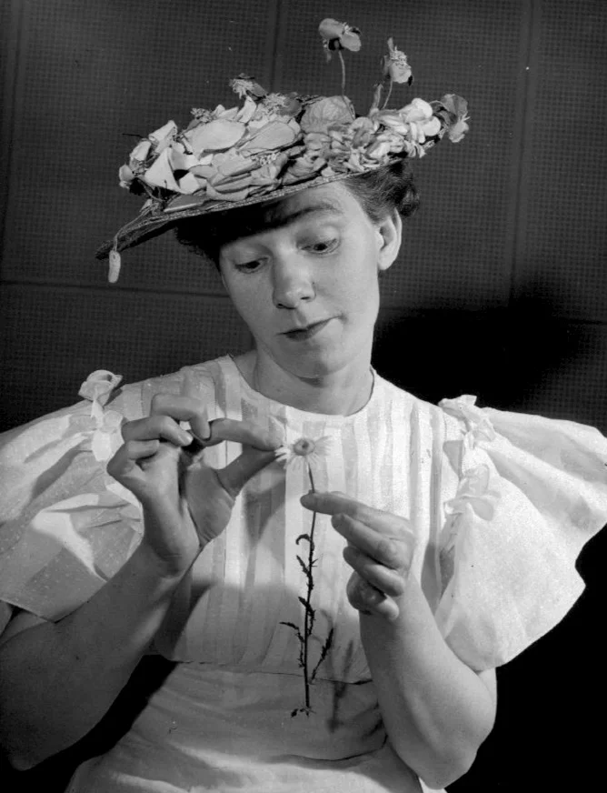 Photo of Minnie Pearl wondering if her latest male interest loves her or not. Grand Ole Opry, 1949. Wikimedia Commons